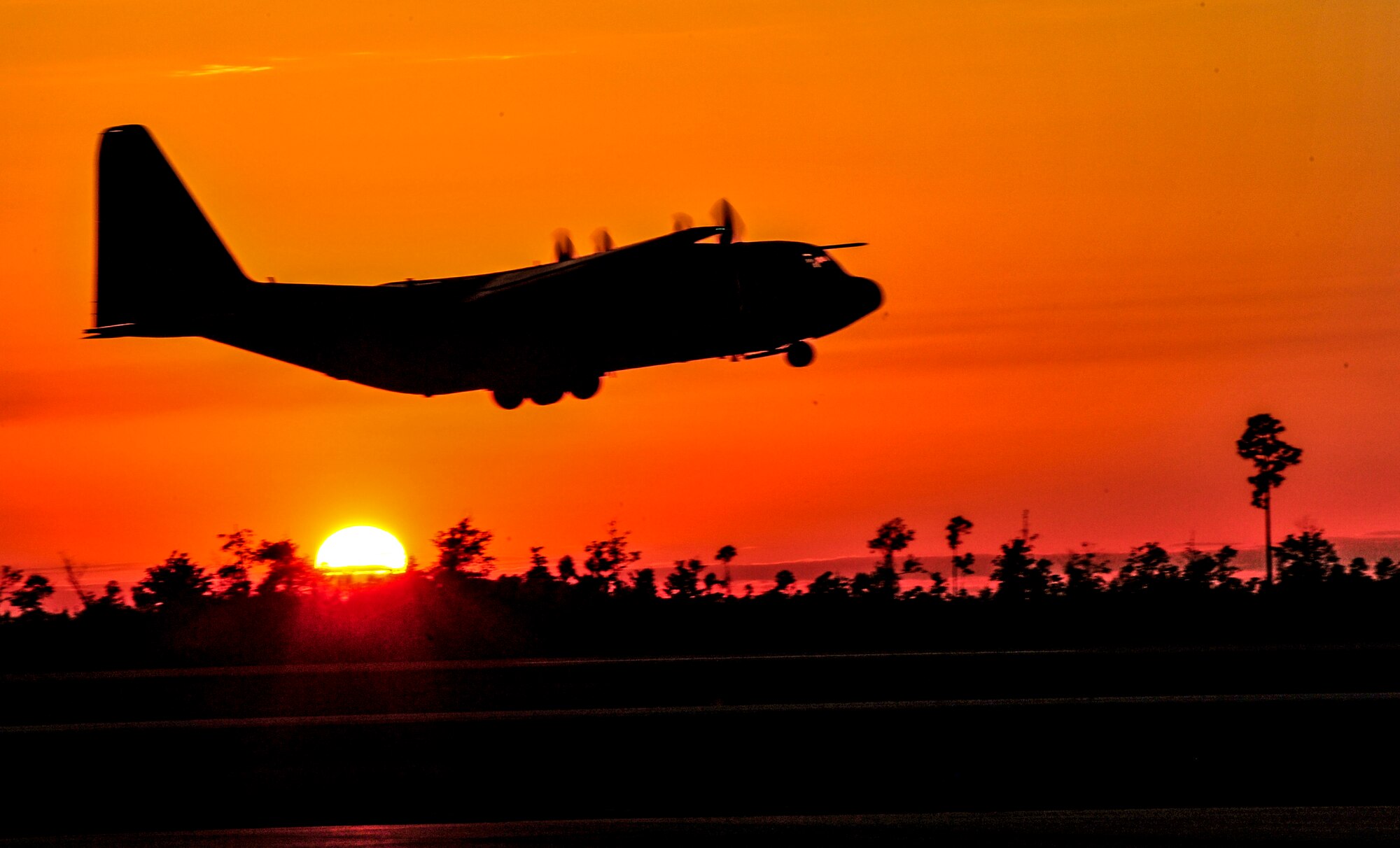 A Lockheed C-130E Hercules aircraft  takes off during Emerald Warrior 2014 at Stennis International Airport, Miss., May 2, 2014. Emerald Warrior is an annual, joint exercise to train special operations, conventional and partner nation forces in combat scenarios designed to hone special operations air and ground combat skills, and is the Department of Defense's only irregular warfare exercise. (U.S. Air Force photo by Senior Airman Colville McFee)