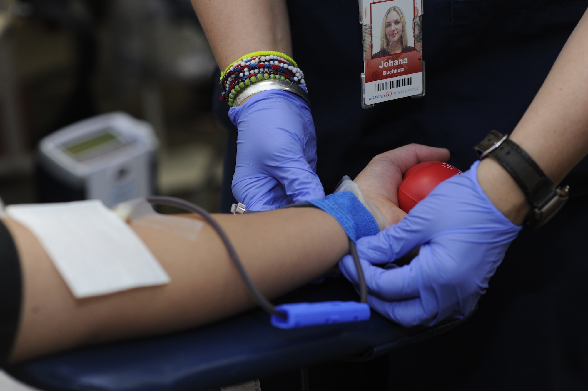 A phlebotomist situates donation tubes during a blood drive May 5, 2014, in the health and wellness center on Buckley Air Force Base, Colo. According to the American Red Cross, more than 41,000 blood donations are needed every day. (U.S. Air Force photo by Airman 1st Class Samantha Saulsbury/Released)