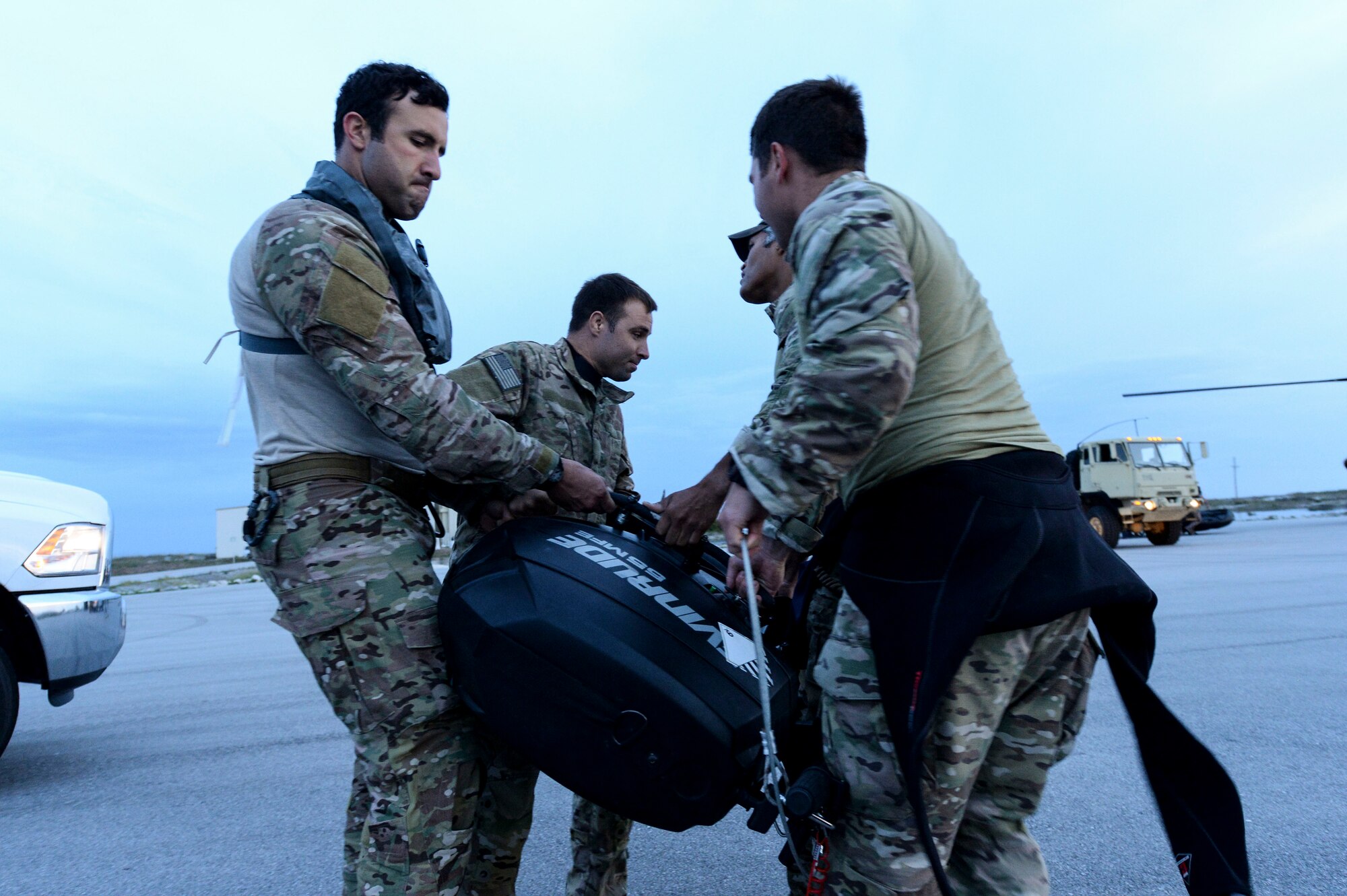 U.S. Army Special Forces members with the U.S. Army 7th Special Forces Group move a Zodiac Combat Rubber Raiding Craft's motor in in preparation for helo-cast training during Emerald Warrior 2014 at Hurlburt Field, Fla., May 2, 2014. Emerald Warrior is an annual, joint exercise to train special operations, conventional and partner nation forces in combat scenarios designed to hone special operations air and ground combat skills, and is the Department of Defense’s only irregular warfare exercise. (U.S. Air Force photo by Senior Airman Nicholas Byers)