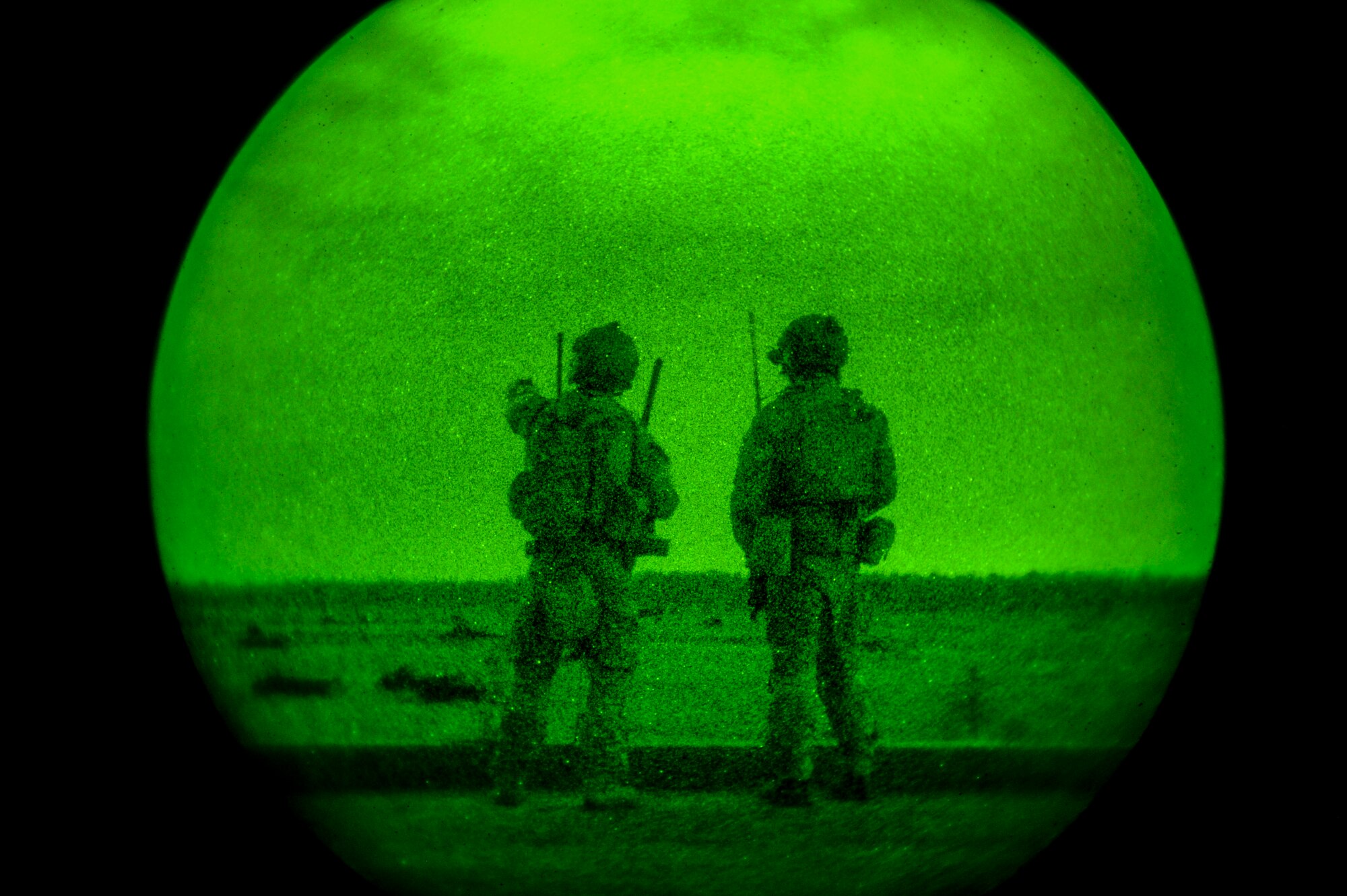 A U.S. Air Force Tactical Air Control Party member (left) points at a target in the field to a U.S. Air Force Combat Controller while participating in close air support training during Emerald Warrior 2014 on Hurlburt Field, Fla., May 1, 2014. Emerald Warrior is an annual, joint exercise to train special operations, conventional and partner nation forces in combat scenarios designed to hone special operations air and ground combat skills, and is the Department of Defense's only irregular warfare exercise. (U.S. Air Force photo by Senior Airman Colville McFee)