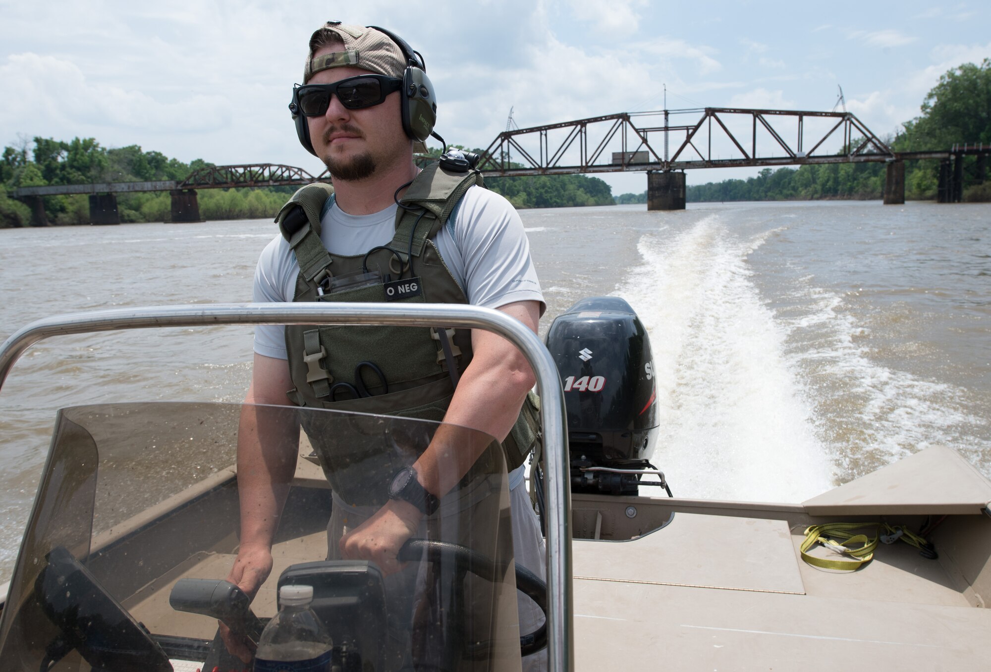 A civilian contractor drives a boat on the Apalachicola River in support of Emerald Warrior 2014 in Chattahoochee, Fla., April 28, 2014. Emerald Warrior is an annual, joint exercise to train special operations, conventional and partner nation forces in combat scenarios designed to hone special operations air and ground combat skills, and is the Department of Defense’s only irregular warfare exercise. (U.S. Air Force photo by Tech. Sgt. Barry Loo)