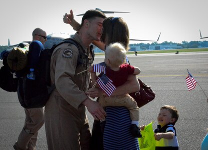 Capt. Aleksander Layne, 17th Airlift Squadron pilot, is met by his wife, Amy, and their two sons, Markus and Rex (far right) during the 17th AS Redeployment May 5, 2014, at Joint Base Charleston, S.C. During their two-month deployment to Southwest Asia, the squadron completed more than 800 sorties, logged in 2,381 flying hours and airlifted more than 28.5 million pounds of cargo and approximately 18,700 passengers. (U.S. Air Force photo/Staff Sgt. AJ Hyatt) 