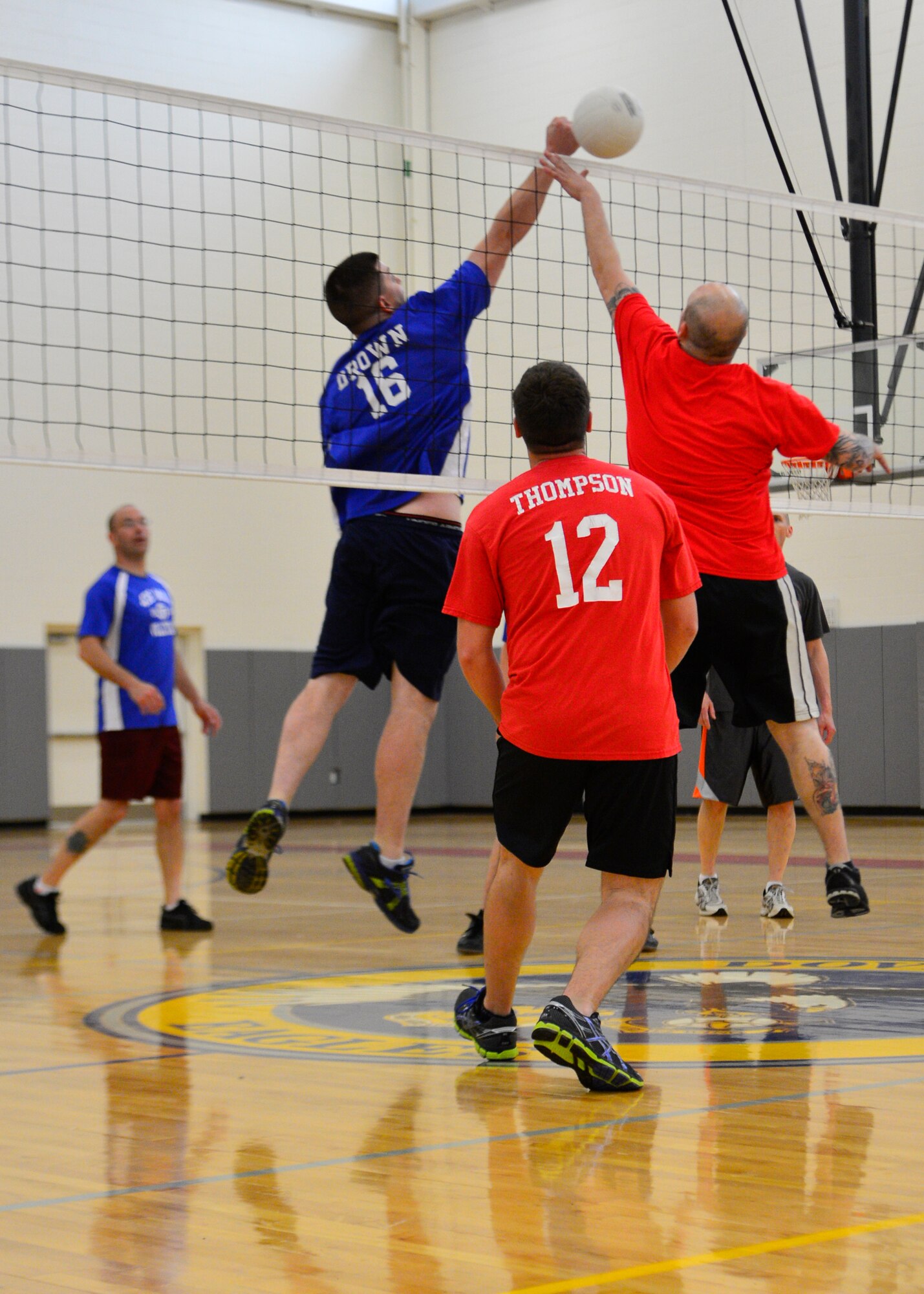 Ross Drown, 436th Maintenance Squadron, tips the ball over the net for a point during an intramural volleyball game May 1, 2014, at the fitness center on Dover Air Force Base, Del. The 436th MXS improved to 6-0 on the season as they defeated the 436th Civil Engineer Squadron 25-16 and 25-22. (U.S. Air Force photo/Airman 1st Class William Johnson) 