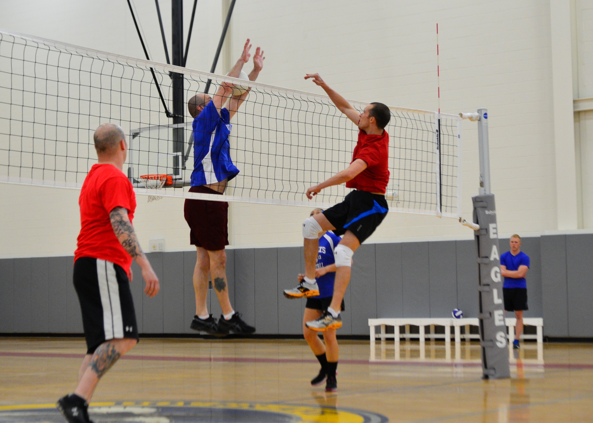 Wayne Birk, 436th Maintenance Squadron, attempts to block a kill from Chris Parks, 436th Civil Engineer Squadron, during an intramural volleyball game May 1, 2014, at the fitness center on Dover Air Force Base, Del. The 436th CES fell short in the match losing 25-16 and 25-22. (U.S. Air Force photo/Airman 1st Class William Johnson)
