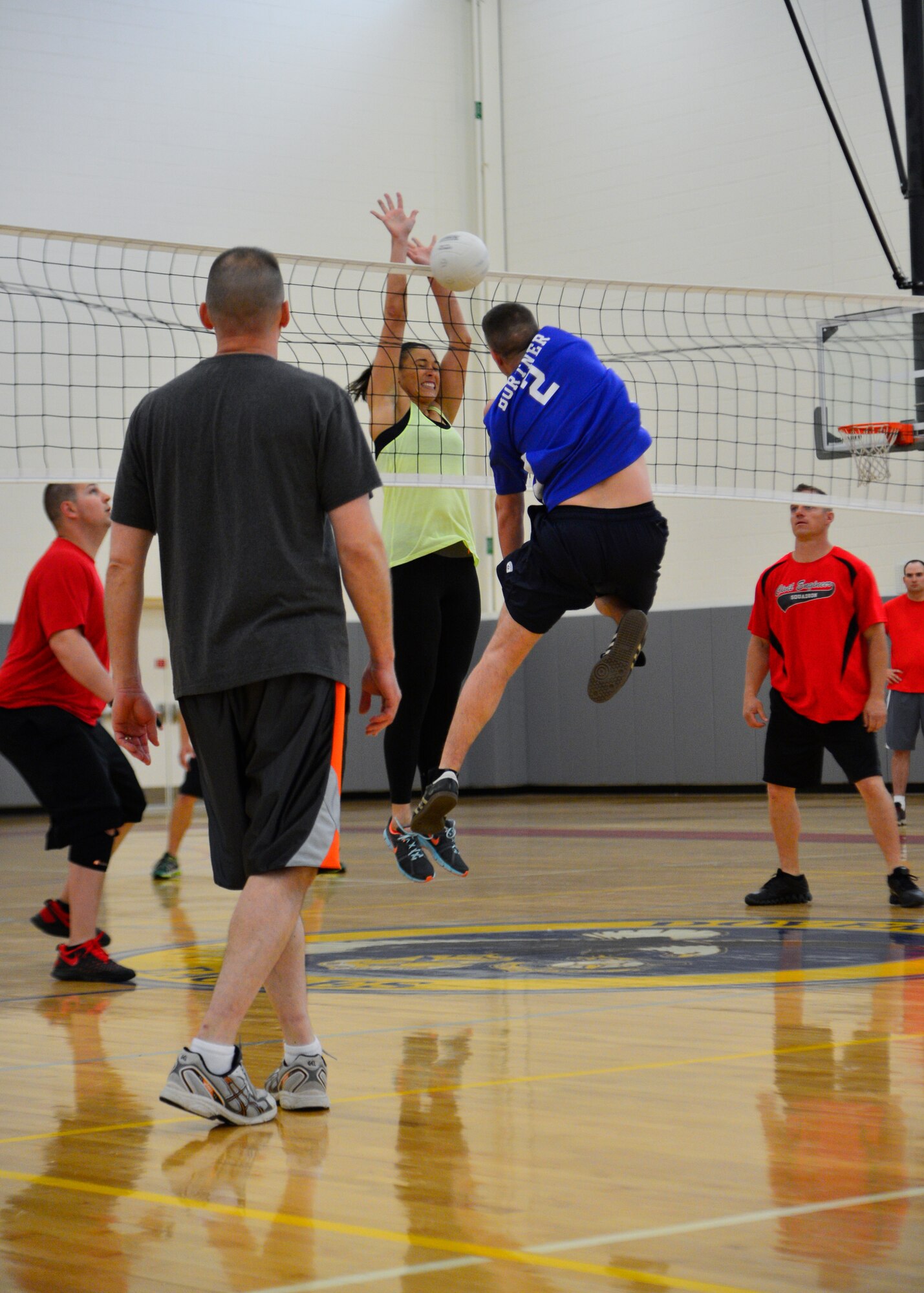 Britini Jennie, 436th Civil Engineer Squadron, blocks an attempted kill from Lawrence Bortner, 436th Maintenance Squadron player-coach, during an intramural volleyball game May 1, 2014, at the fitness center on Dover Air Force Base, Del. The 436th MXS swept the 436th CES 25-16 and 25-22 and advanced to 6-0 for the season. (U.S. Air Force photo/Airman 1st Class William Johnson)