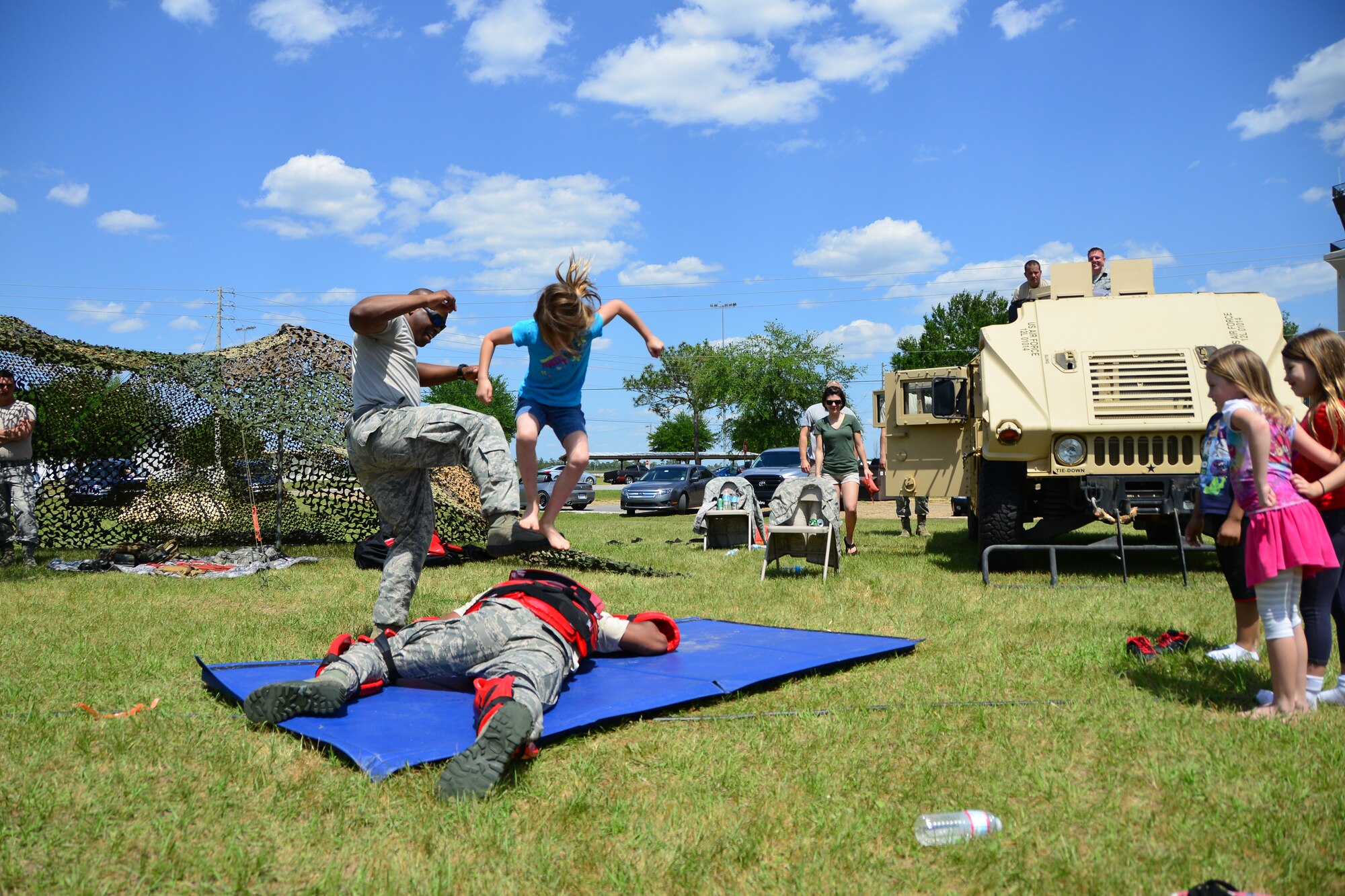 Aaralyn Baldwin, 7, pounces on her victim for the self-defense demonstration during Duke Field’s Family Day event May 3.  The 919th Special Operations Wing sets aside a special day each year to show appreciation for its reservists and their family members. Events included music, sports, children’s games, etc. (U.S. Air Force photo/Tech. Sgt. Jasmin Taylor)