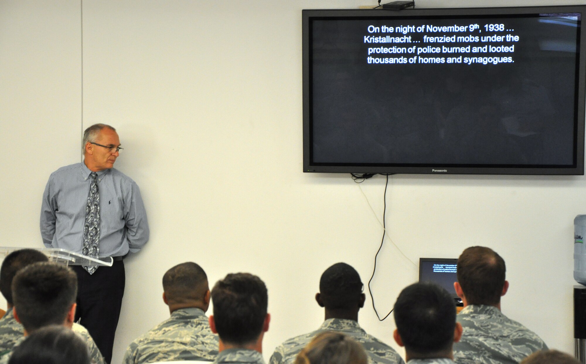 GOODFELLOW AIR FORCE BASE, Texas – John V. Garrett, 17th Training Wing historian, shows a silent slideshow for Holocaust Remembrance Week at the Fellowship Hall here April 29. Once the slideshow finished, Garrett shared his insight about the Holocaust. (U.S. Air Force photo/ Senior Airman Joshua Edwards)