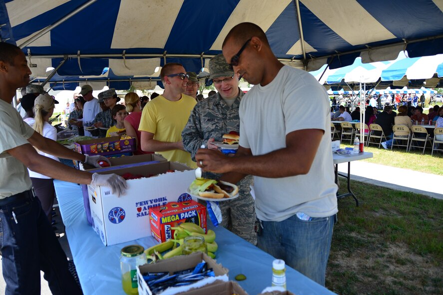 Airmen and family members prepare their plates during Duke Field’s Family Day event May 3.  The 919th Special Operations Wing sets aside a special day each year to show appreciation for its reservists and their family members. Events included music, sports, children’s games, etc. (U.S. Air Force photo/Tech. Sgt. Jasmin Taylor)