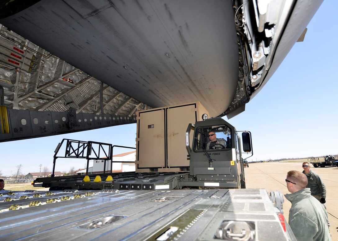 30th Aerial Port Squadron members from the 914th Airlift Wing load equipment on to a C-17 transient aircraft at the Niagara Falls Air Reserve Station, N.Y. April 24, 2014.  This aircraft and equipment was used in support of a Warrior Exercise at Ft. McCoy, Wis.  (U.S. Air Force photo by Tech. Sgt. Joseph McKee)