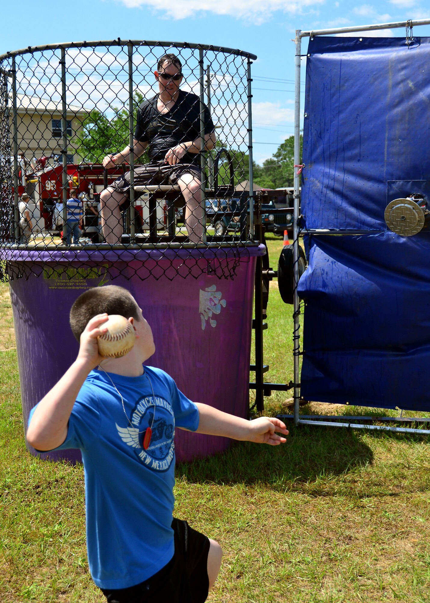 Major Jeffrey Powell, 919th Special Operations Maintenance Squadron, takes his turn sitting in the dunking booth during Duke Field’s Family Day event May 3.  The 919th Special Operations Wing sets aside a special day each year to show appreciation for its reservists and their family members. Events included music, sports, children’s games, etc. (U.S. Air Force photo/Tech. Sgt. Cheryl L. Foster)