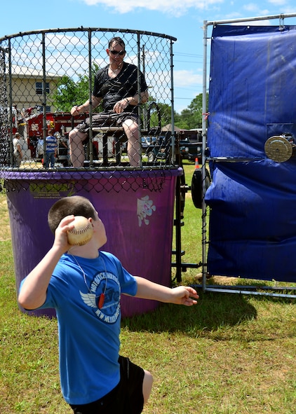 Major Jeffrey Powell, 919th Special Operations Maintenance Squadron, takes his turn sitting in the dunking booth during Duke Field’s Family Day event May 3.  The 919th Special Operations Wing sets aside a special day each year to show appreciation for its reservists and their family members. Events included music, sports, children’s games, etc. (U.S. Air Force photo/Tech. Sgt. Cheryl L. Foster)
