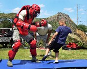 A young family member tests his might in the self-defense demonstration during Duke Field’s Family Day event May 3.  The 919th Special Operations Wing sets aside a special day each year to show appreciation for its reservists and their family members. Events included music, sports, children’s games, etc. (U.S. Air Force photo/Tech. Sgt. Cheryl L. Foster)