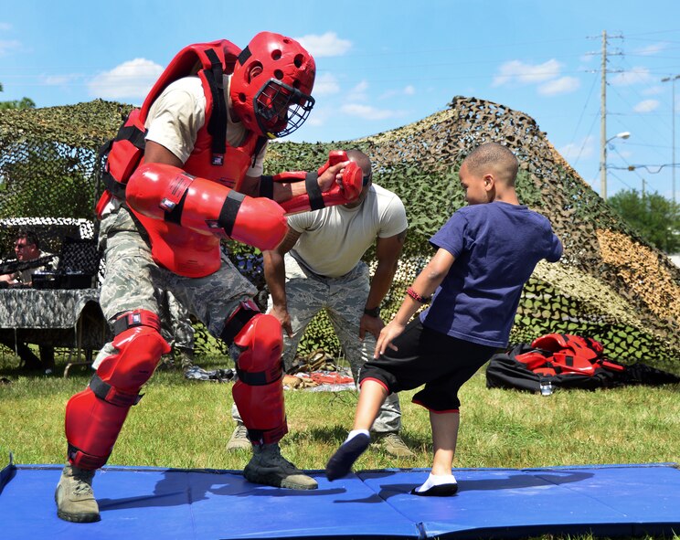 A young family member tests his might in the self-defense demonstration during Duke Field’s Family Day event May 3.  The 919th Special Operations Wing sets aside a special day each year to show appreciation for its reservists and their family members. Events included music, sports, children’s games, etc. (U.S. Air Force photo/Tech. Sgt. Cheryl L. Foster)