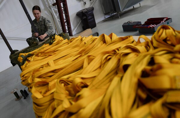 Staff Sgt. Samantha Monroe, 5th Operations Support Squadron aircrew flight equipment technician from Minot Air Force Base, N.D. on temporary duty at Ellsworth, prepares to pack a drag parachute for a B-52 Stratofortress at Ellsworth Air Force Base, S.D., April 30, 2014. The 90-foot parachute weighs approximately 200 pounds when fully packed and deploys as an aircraft lands, helping to slow down the aircraft. (U.S. Air Force photo by Senior Airman Zachary Hada/Released)