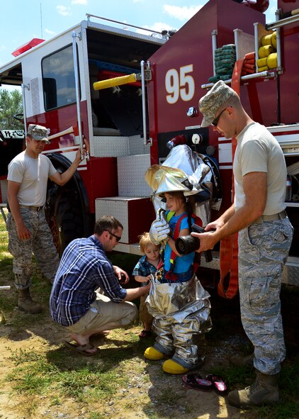 Airmen from the fire department show family members how to don their protective gear during Duke Field’s Family Day event May 3.  The 919th Special Operations Wing sets aside a special day each year to show appreciation for its reservists and their family members. Events included music, sports, children’s games, etc. (U.S. Air Force photo/Tech. Sgt. Cheryl L. Foster)