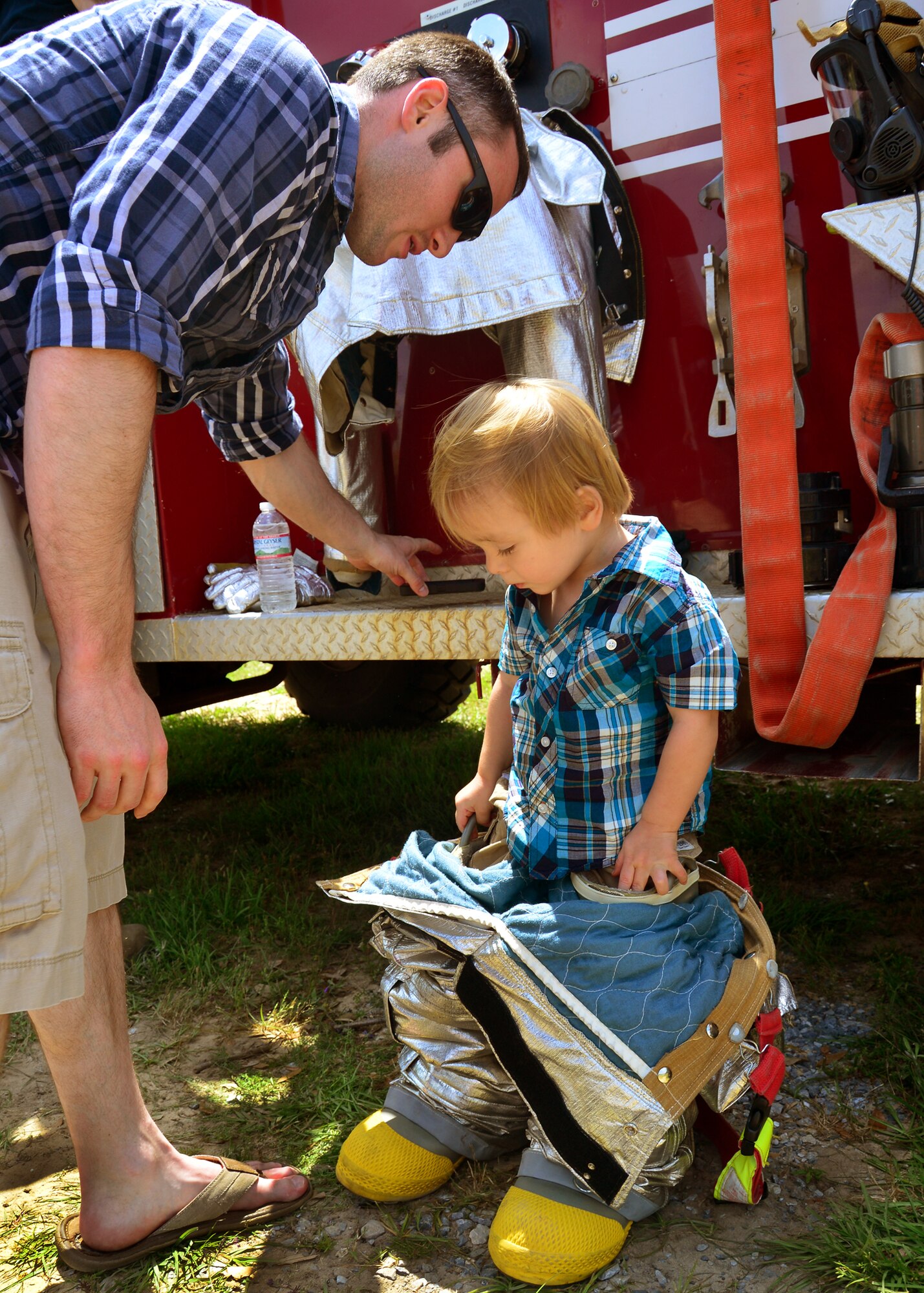 A young boy tries on the fire department’s protective gear during Duke Field’s Family Day event May 3.  The 919th Special Operations Wing sets aside a special day each year to show appreciation for its reservists and their family members. Events included music, sports, children’s games, etc. (U.S. Air Force photo/Tech. Sgt. Cheryl L. Foster)