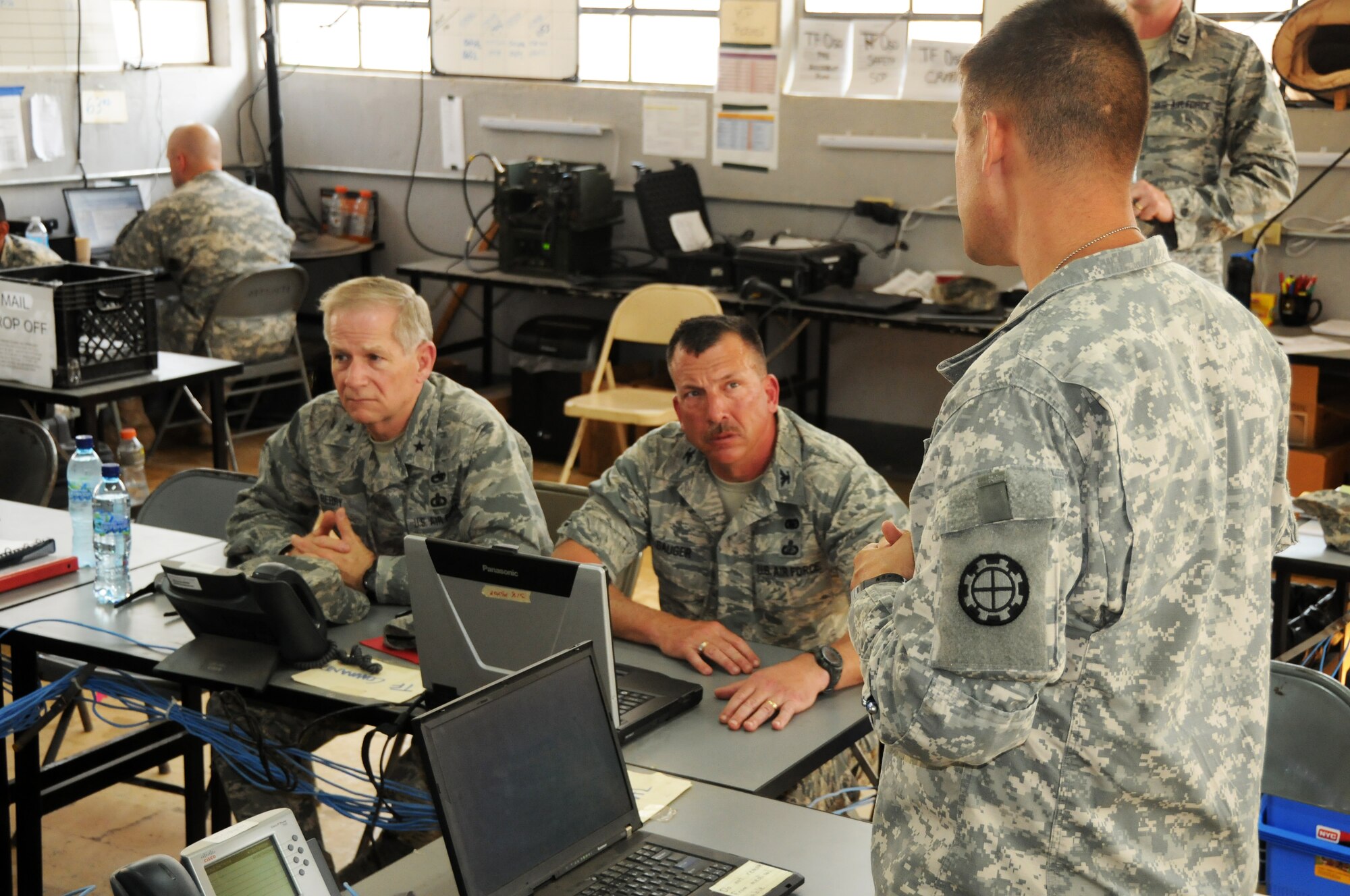 Brig. Gen. Mark Berry, Arkansas Air National Guard chief of staff, left, and Col. Pete Gauger, 188th Fighter Wing vice commander, middle; receive a mission briefing at a Guatemalan Army base in Zacapa April 14, 2014. The 188th Civil Engineer Squadron deployed to Guatemala in support of a U.S. Army South-led humanitarian mission called Beyond the Horizon.  The 188th Airmen were there to build a school in the remote town of El Robles, Guatemala. (U.S. Air National Guard photo by Maj. Heath Allen/released)