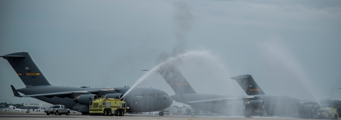 A C-17 Globemaster III taxi’s under water hoses May 5, 2014, on the flightline at Joint Base Charleston, S.C. Col. Darren Hartford was piloting the C-17 for his final flight as the 437th Airlift Wing commander. The final or "fini flight," is an aviation tradition in which aircrew members are met by their unit comrades, family and friends and soaked with water. (U.S. Air Force photo/ Airman 1st Class Clayton Cupit)