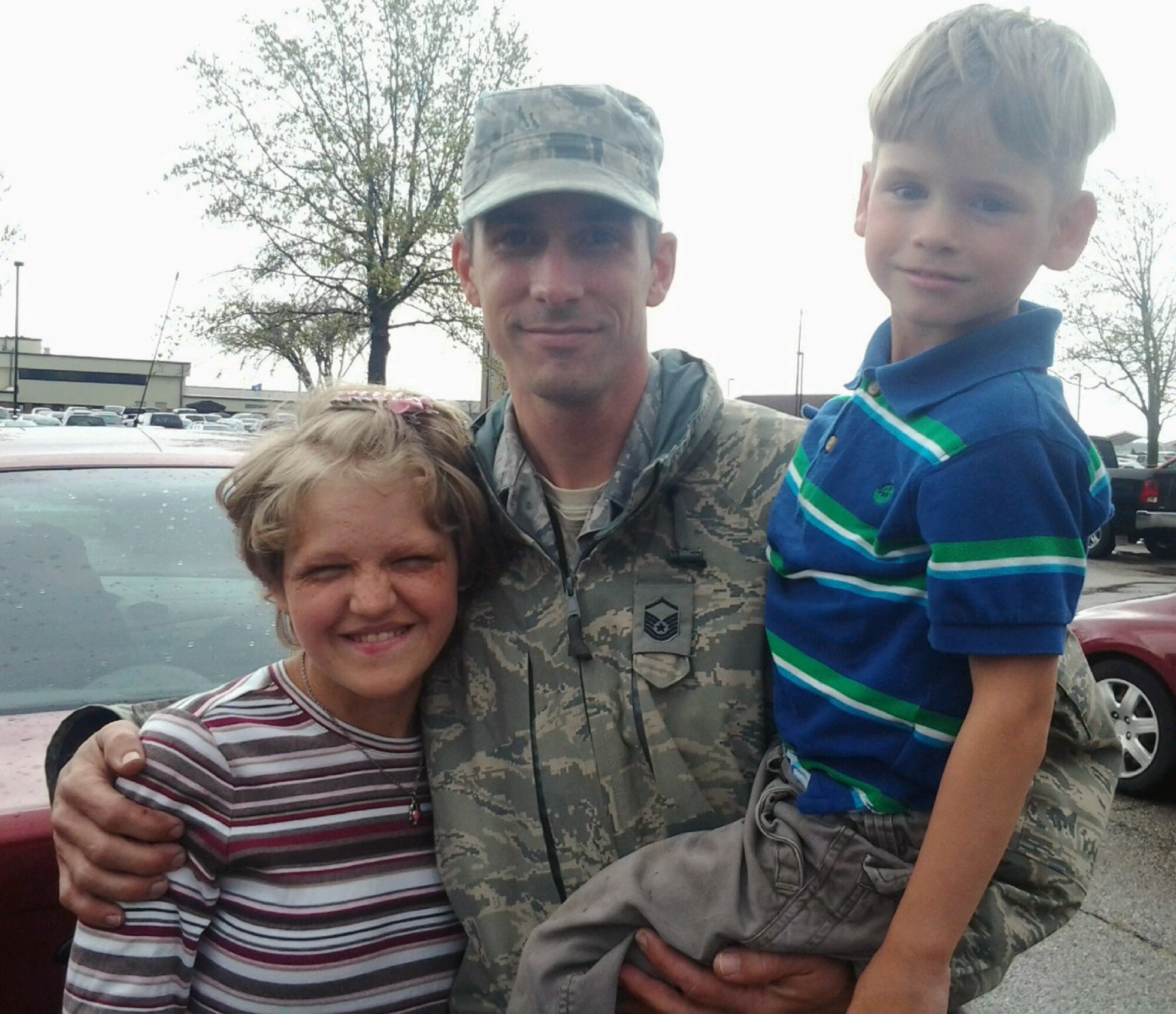 Master Sgt. Jay Scoda, 509th Aircraft Maintenance Squadron special section chief, poses with the two newest additions to his family, Iryna and Jayson. Scoda and his wife, Trina, recently adopted the children. (Courtesy photo)