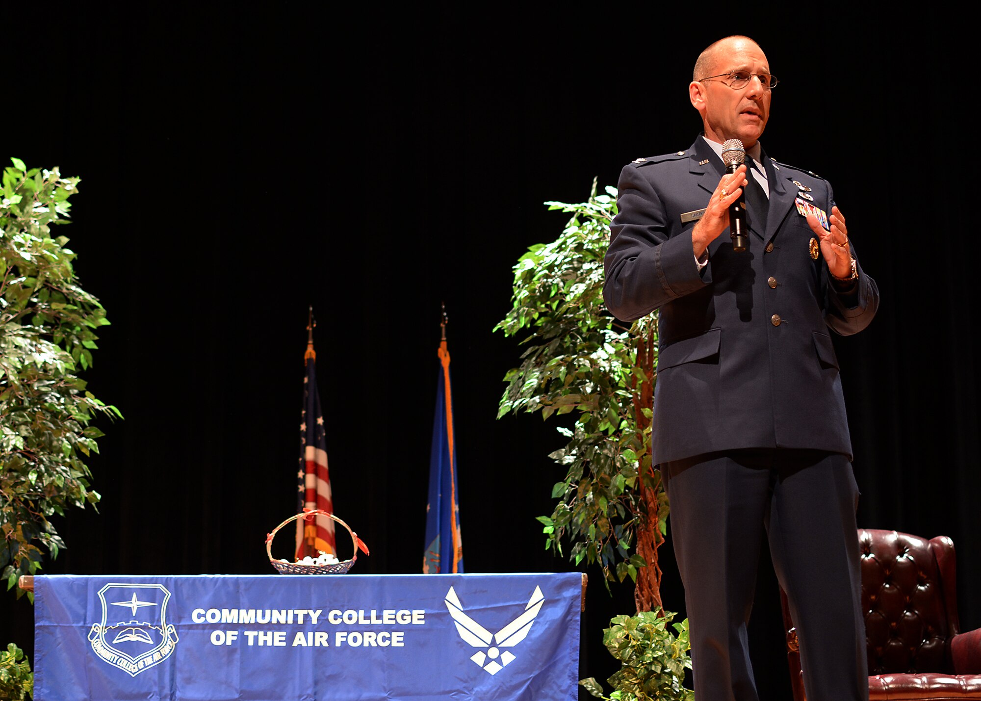 Col. Scott Sauter, 315th Airlift Wing speaks at a Community College of the Air Force ceremony in the base theater.  Hundreds of family members and friends gathered at  May 5, 2014 at Joint Base Charleston, South Carolina to celebrate the academic accomplishments of 64 Community College of the Air Force graduates. (U.S. Photo by Tech. Sgt. Shane Ellis)

