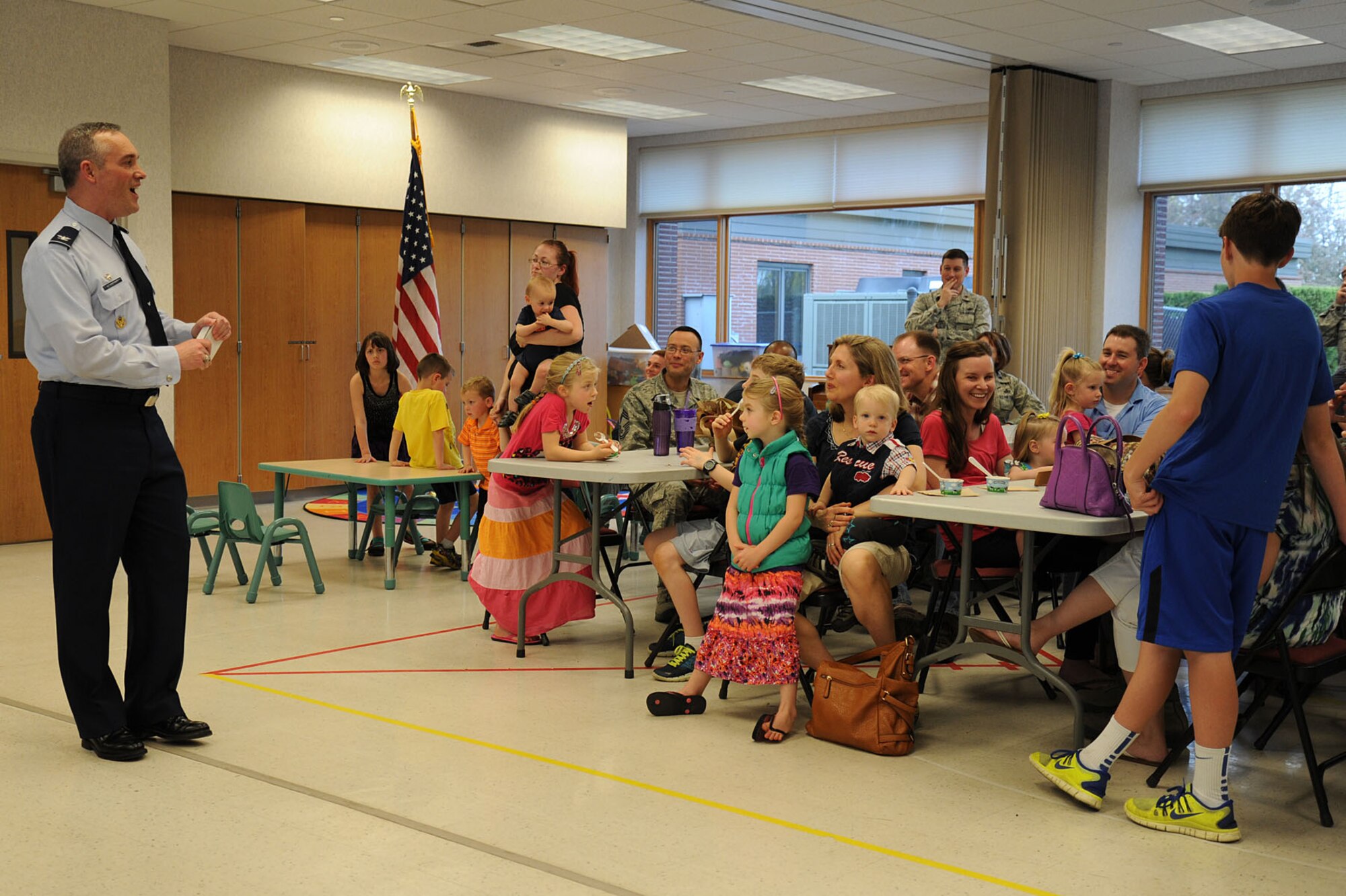 Col. Brian Newberry speaks with Key Spouses and their families during the Key Spouse ice cream social at Fairchild Air Force Base, Wash., May 1, 2014. The social was hosted by Col. Brian Newberry and his wife, Jill, to thank spouses for their sacrifice and support for Team Fairchild. Newberry is the 92nd Air Refueling Wing commander. (U.S. Air Force photo by Airman 1st Class Janelle Patiño/Released)
