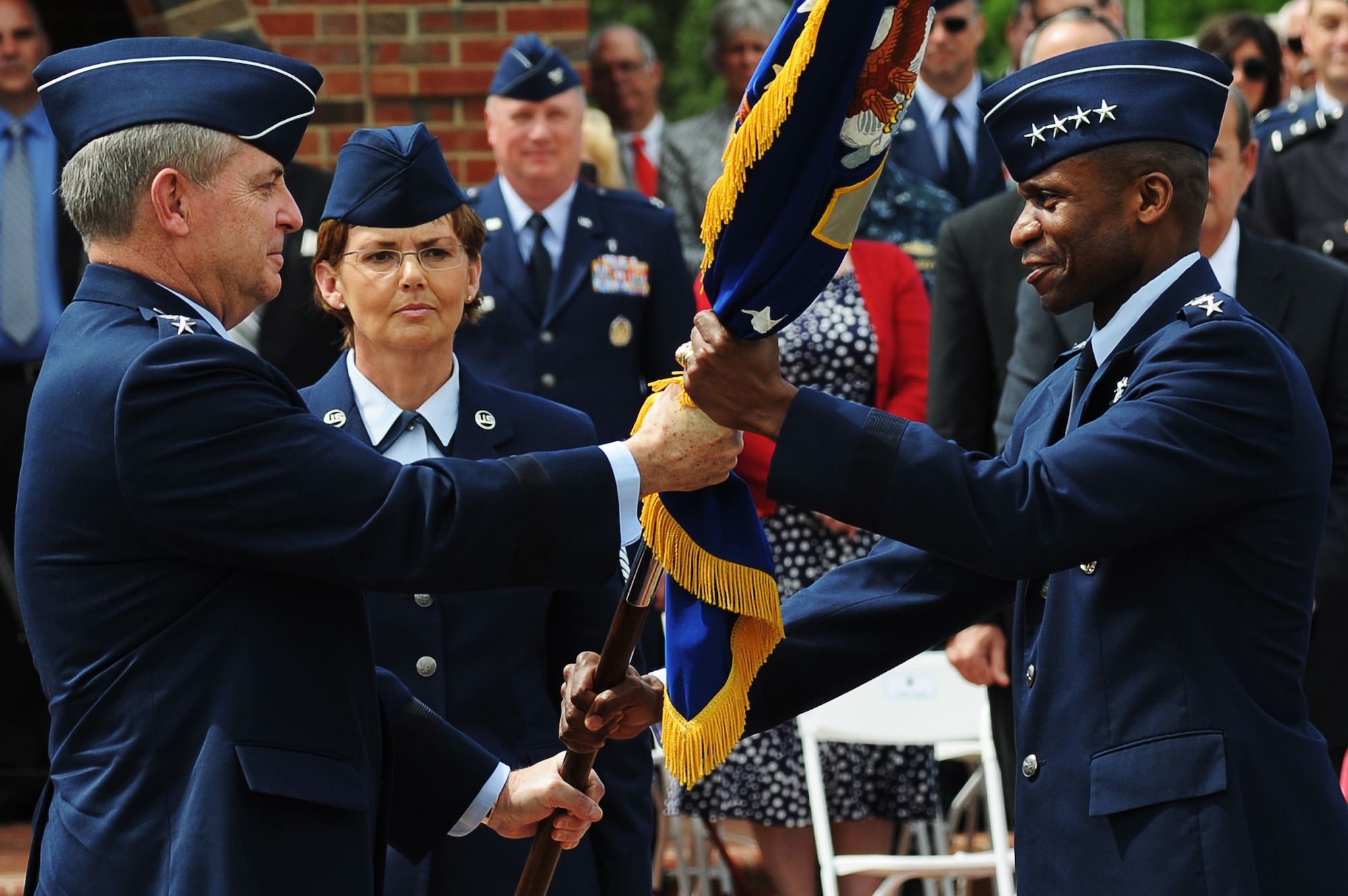 Gen. Mark A. Welsh III, Air Force Chief of Staff, passes Air Mobility Command’s guidon May 5, 2014 to Gen. Darren W. McDew during a change of command ceremony at Scott Air Force Base, Illinois. McDew is the 11th commander of AMC since its activation June 1, 1992. (U.S. Air Force photo/Senior Airman Tristin English/RELEASED)