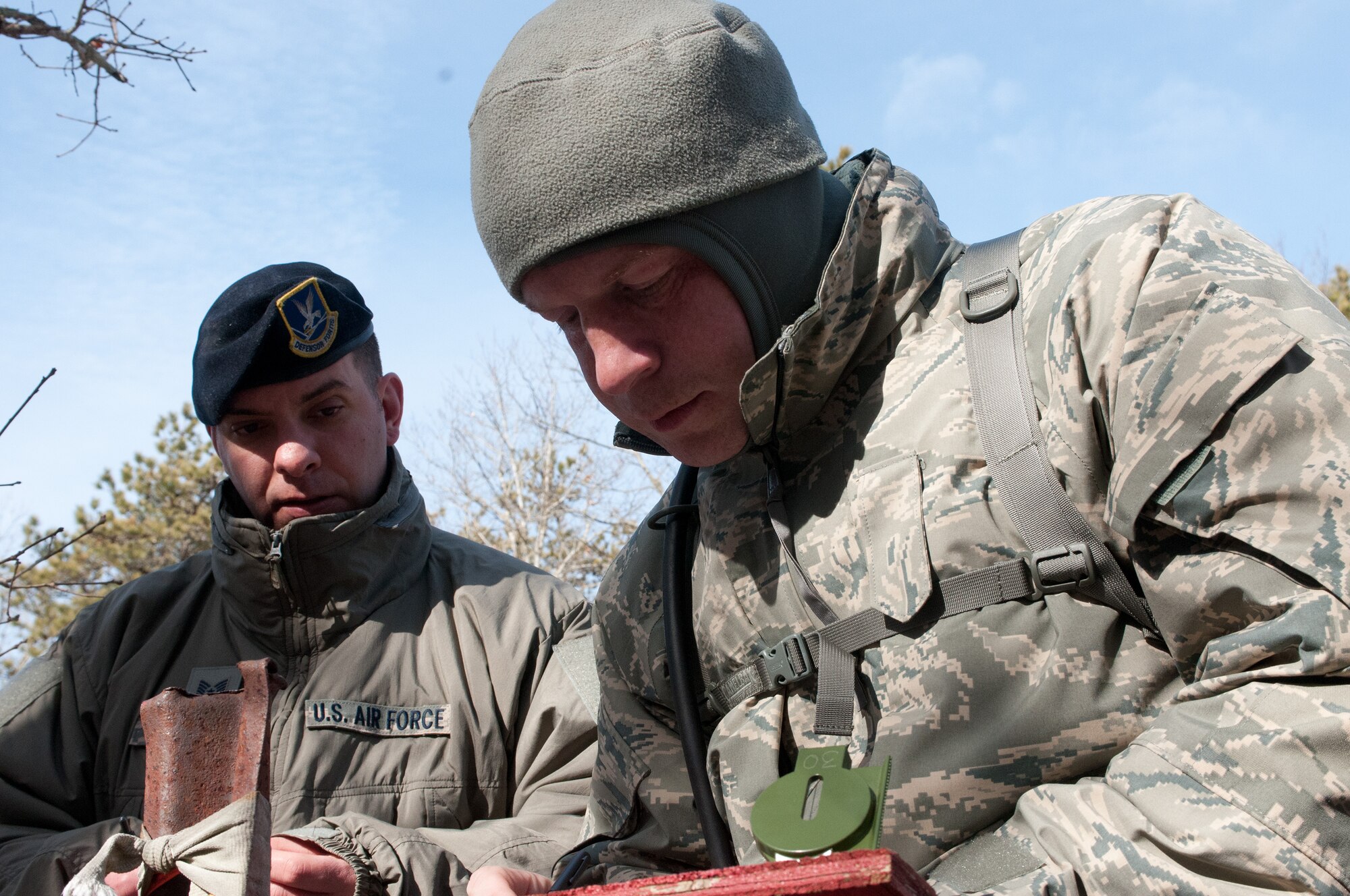 Senior Airman Adam Souza, of the 102nd Intelligence Wing, studies a map as he prepares to start the land navigation portion of the Best Airman Warrior competition on Joint Base Cape Cod, March 1, 2014. The competition tested Airmen in areas like shooting, land navigation, and physical fitness. (National Guard photo by Staff Sgt. Jeremy Bowcock/Released)