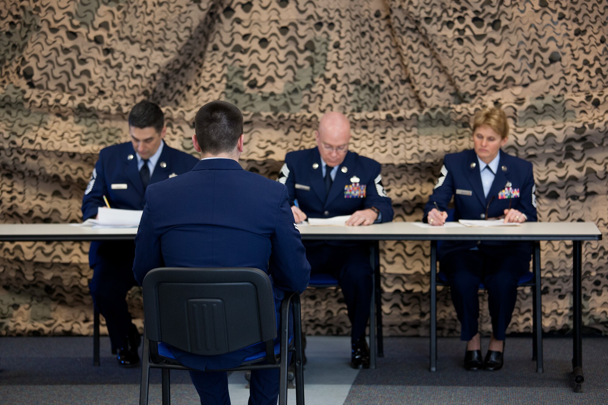 A panel of Chief Master Sergeants prepare to interview Airmen from the 102nd Intelligence Wing and the 104th Fighter Wing in the Best Airman Warrior competition on Joint Base Cape Cod, February 28, 2014. The competition tested Airmen in areas like military knowledge, land navigation, and physical fitness. (National Guard photo by Staff Sgt. Jeremy Bowcock/Released) Bowcock/Released)