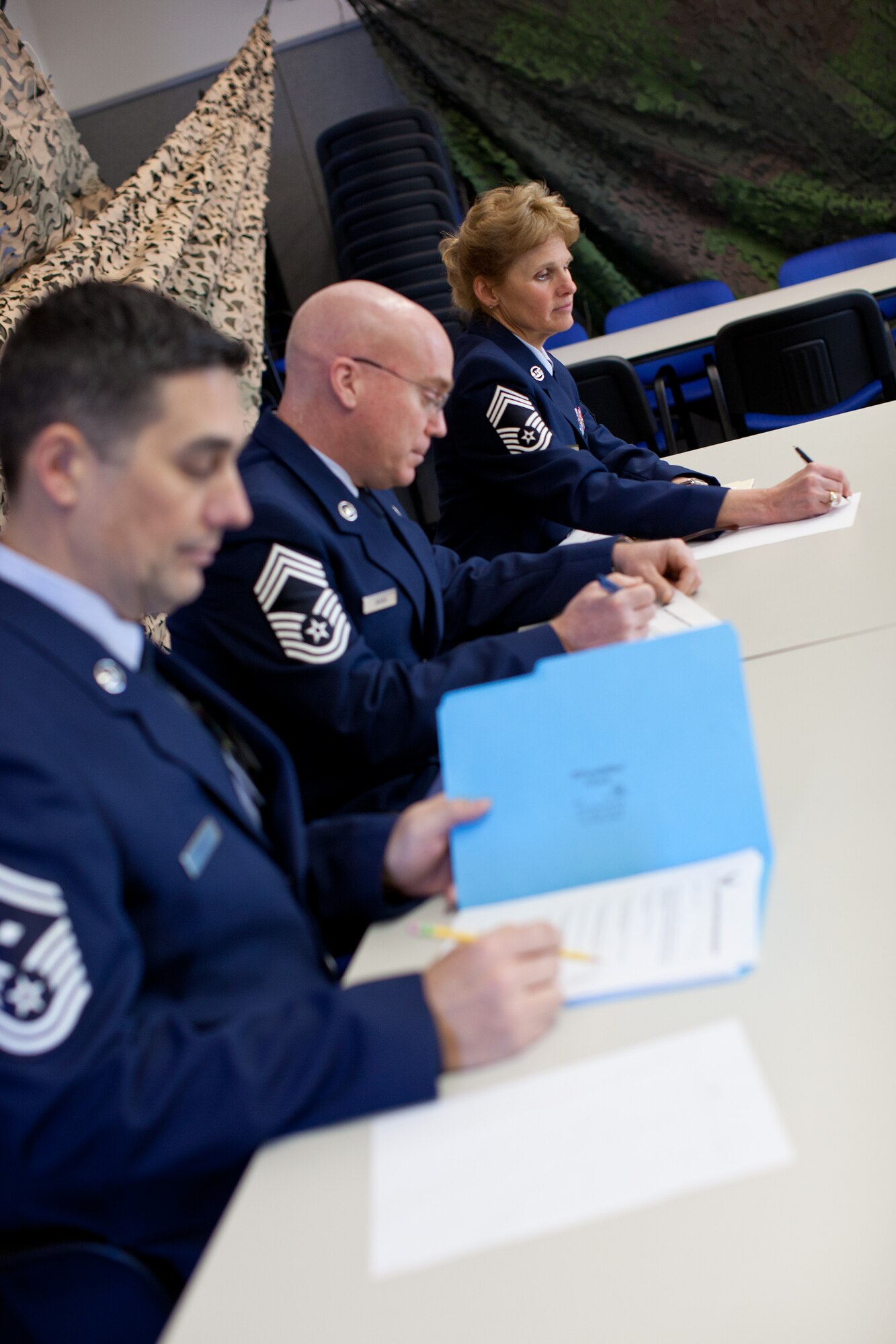 A panel of Chief Master Sergeants prepare to interview Airmen from the 102nd Intelligence Wing and the 104th Fighter Wing in the Best Airman Warrior competition on Joint Base Cape Cod, February 28, 2014. The competition tested Airmen in areas like military knowledge, land navigation, and physical fitness. (National Guard photo by Staff Sgt. Jeremy Bowcock/Released)