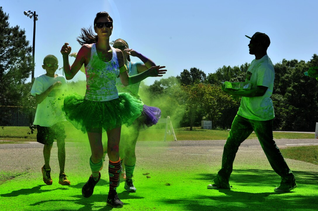 A group of friends dressed in tutus run in the Maxwell Air Force Base color run May 3, 2014. Some participants dressed up for the event, while others wore regular running attire. The 42nd Force Support Squadron fitness and outdoor recreation centers hosted the event to celebrate fitness month.  (U.S. Air Force photo by Staff Sgt. Natasha Stannard)