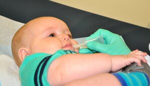 Kristin Bracey, Naval Health Clinic Charleston nurse, administerss an oral vaccine to 6-month-old Gavin Wagner, son of Katlyn Wagner and Petty Officer 3rd Class Kenneth Wagner, a Nuclear Power Training Unit student. 
	
April 26 through May 3 was National Infant Immunization Week and the month of May is Toddler Immunization Month. Both campaigns are annual observances highlighting the importance of routine immunizations for children younger than 2-years old. Immunizations are one of the best ways parents can protect their infants from 14 serious childhood diseases. The Centers for Disease Control and Prevention recommends that you vaccinate your child according to the schedules posted here: http://www.cdc.gov/vaccines/schedules/index.html?s_cid=cs_001. (U.S. Navy photo/Kris Patterson)
