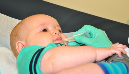 Kristin Bracey, Naval Health Clinic Charleston nurse, administerss an oral vaccine to 6-month-old Gavin Wagner, son of Katlyn Wagner and Petty Officer 3rd Class Kenneth Wagner, a Nuclear Power Training Unit student. 
	
April 26 through May 3 was National Infant Immunization Week and the month of May is Toddler Immunization Month. Both campaigns are annual observances highlighting the importance of routine immunizations for children younger than 2-years old. Immunizations are one of the best ways parents can protect their infants from 14 serious childhood diseases. The Centers for Disease Control and Prevention recommends that you vaccinate your child according to the schedules posted here: http://www.cdc.gov/vaccines/schedules/index.html?s_cid=cs_001. (U.S. Navy photo/Kris Patterson)
