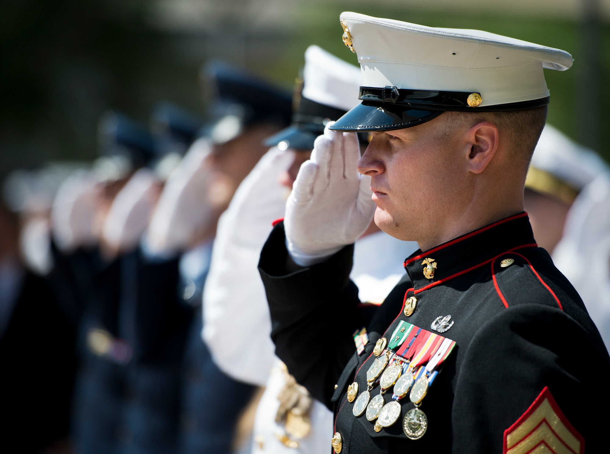 A Marine salutes during the retiring of the colors at the 45th Annual Explosive Ordnance Disposal Memorial Ceremony May 3, at Eglin Air Force Base, Fla. Eight new names of Army and Marine EOD technicians, who lost their lives, were added to the Memorial Wall this year.  The all-service total now stands at 306. (U.S. Air Force photo/Tech. Sgt. Sam King)