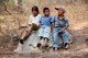 Guatemalan children watch as Airmen with the 188th Civil Engineer Squadron load cinder blocks in preparation to build a school in El Robles, Guatemala, April 14, 2014, in support of Beyond the Horizon, which is a U.S. partnership with the government of Guatemala conducting various medical, dental and civic actions programs, providing focused humanitarian assistance. (U.S. Air National Guard photo by Maj. Heath Allen)