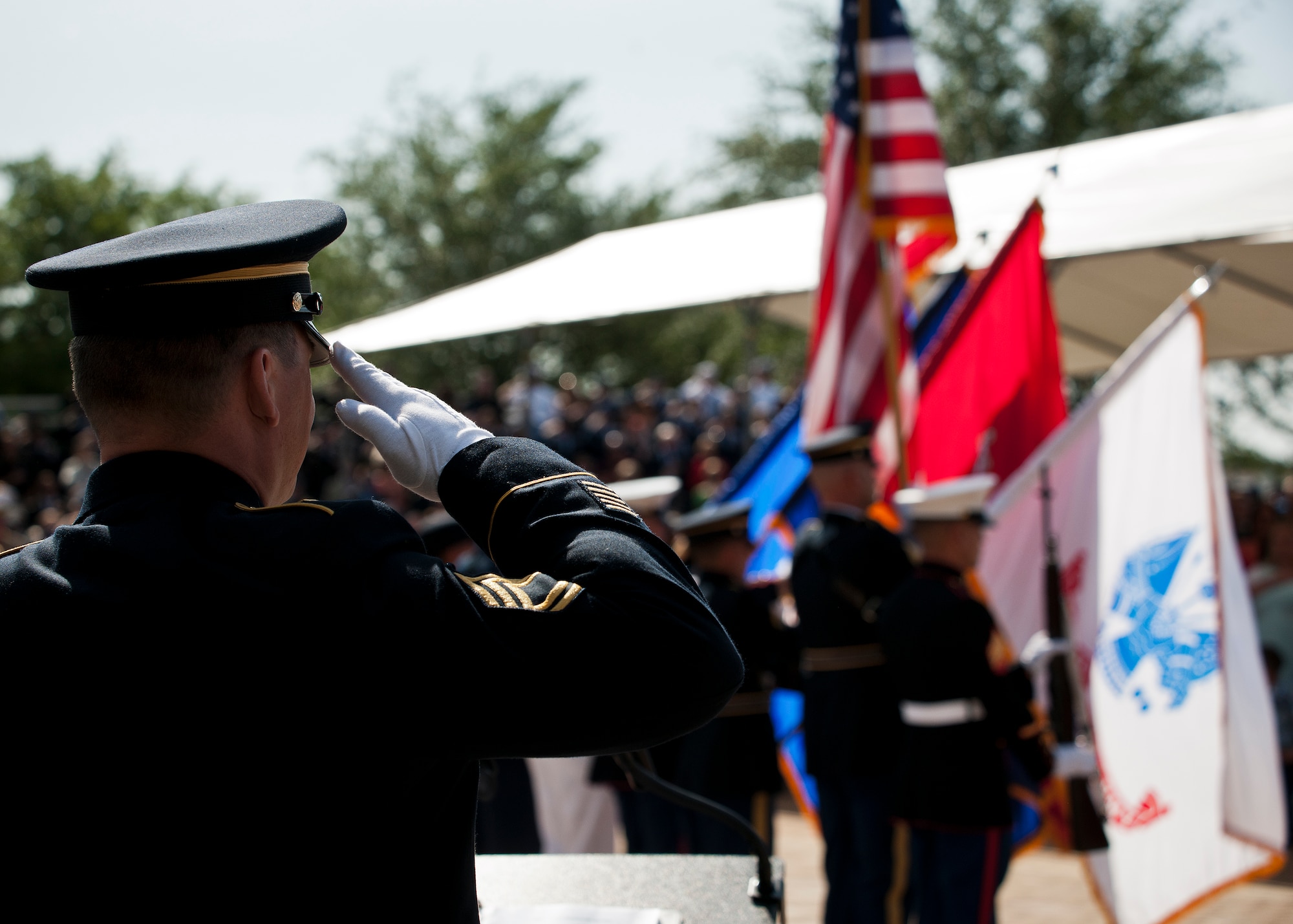 Sgt. 1st Class Joshua Peltz, the master of ceremony for the 45th Annual Explosive Ordnance Disposal Memorial Service, salutes during the presentation of the colors May 3, at Eglin Air Force Base, Fla. Eight new names of Army and Marine EOD technicians, who lost their lives, were added to the Memorial Wall this year.  The all-service total now stands at 306. (U.S. Air Force photo/Tech. Sgt. Sam King)