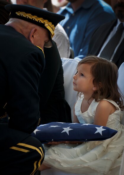Army Chief of Staff Gen. Ray Odierno comforts Audrey Baker, daughter of Sgt. 1st Class Jeff Baker, during the 45th Annual Explosive Ordnance Disposal Memorial Ceremony May 3, at Eglin Air Force Base, Fla. Eight new names of Army and Marine EOD technicians, who lost their lives, were added to the Memorial Wall this year.  The all-service total now stands at 306. (U.S. Air Force photo/Tech. Sgt. Sam King)