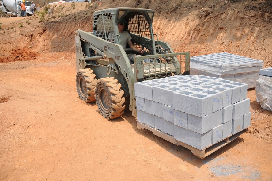 Airmen with the 188th Civil Engineer Squadron load cinder blocks in preparation to build a school in El Robles, Guatemala, April 14, 2014, in support of Beyond the Horizon, which is a U.S. partnership with the government of Guatemala conducting various medical, dental and civic actions programs, providing focused humanitarian assistance. (U.S. Air National Guard photo by Maj. Heath Allen)