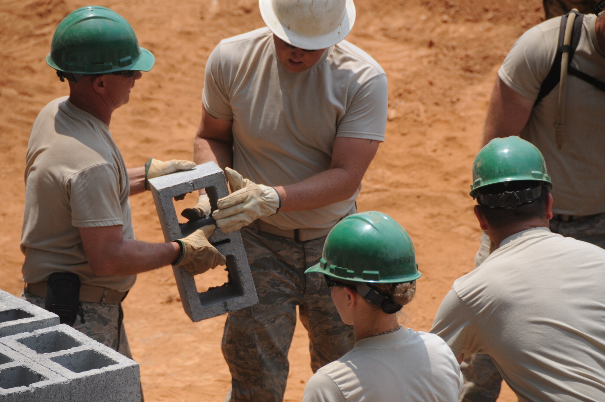 Airmen with the 188th Civil Engineer Squadron load cinder blocks in preparation to build a school in El Robles, Guatemala, April 14, 2014, in support of Beyond the Horizon, which is a U.S. partnership with the government of Guatemala conducting various medical, dental and civic actions programs, providing focused humanitarian assistance. (U.S. Air National Guard photo by Maj. Heath Allen)