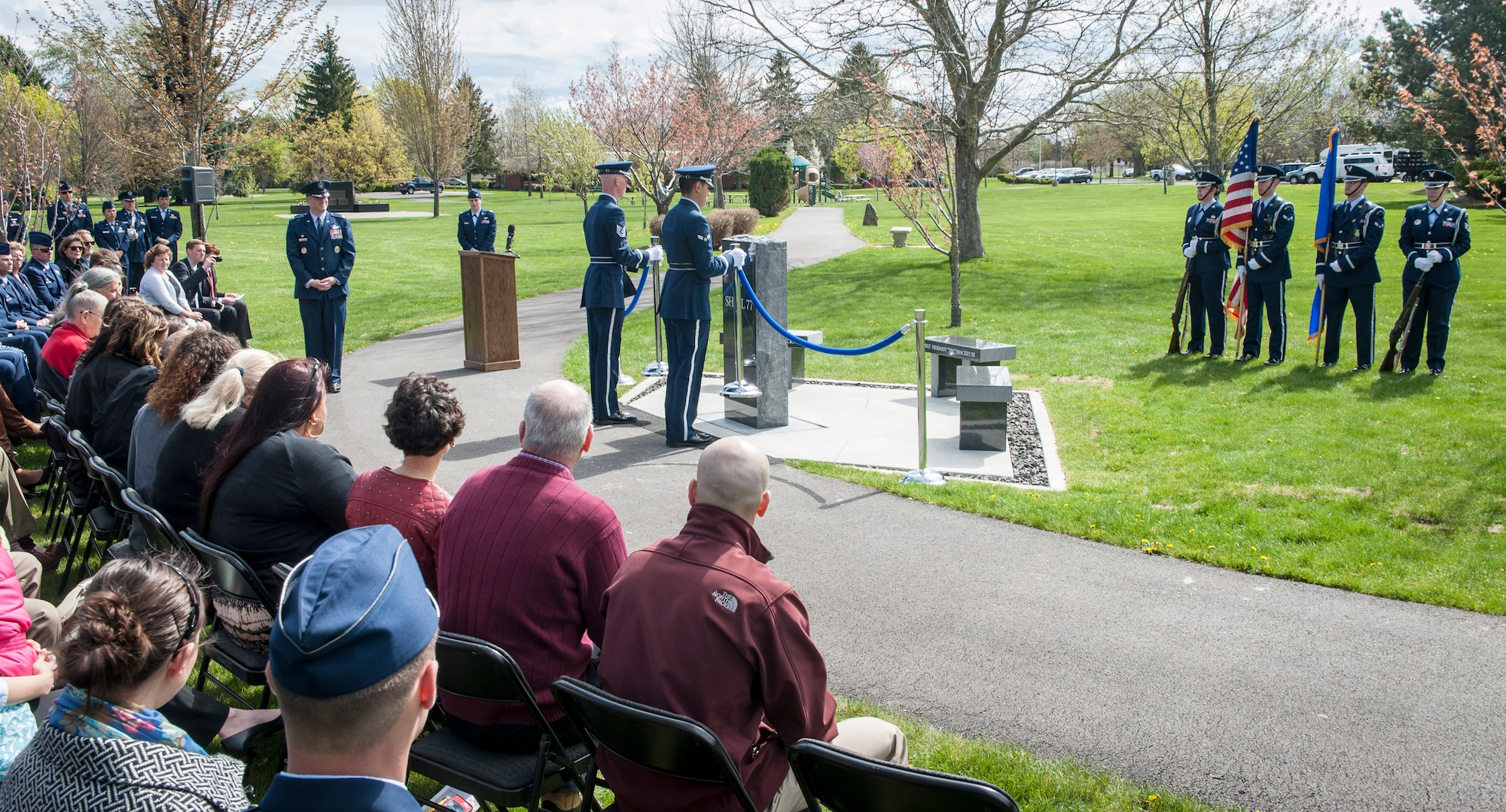 Family, friends, coworkers and neighbors of three fallen Fairchild Airmen who tragically perished one year ago in a KC-135 Stratotanker crash in northern Kyrgyzstan watch as a the base honor guard officially “pull the ropes” during a memorial dedication ceremony in the Fairchild Memorial Grove Park at Fairchild Air Force Base, Wash., May 3, 2014. "Shell 77" crewmembers honored were Capt. Mark T. "Tyler" Voss, Capt. Victoria A. "Tori" Pinckney and Tech. Sgt. Herman "Tre" Mackey III. During the ceremony, a granite memorial featuring a centerpiece and three benches were unveiled honoring these three Airmen keeping their memory alive at Fairchild. (U.S. Air Force photo by Staff Sgt. Benjamin W. Stratton/Released)