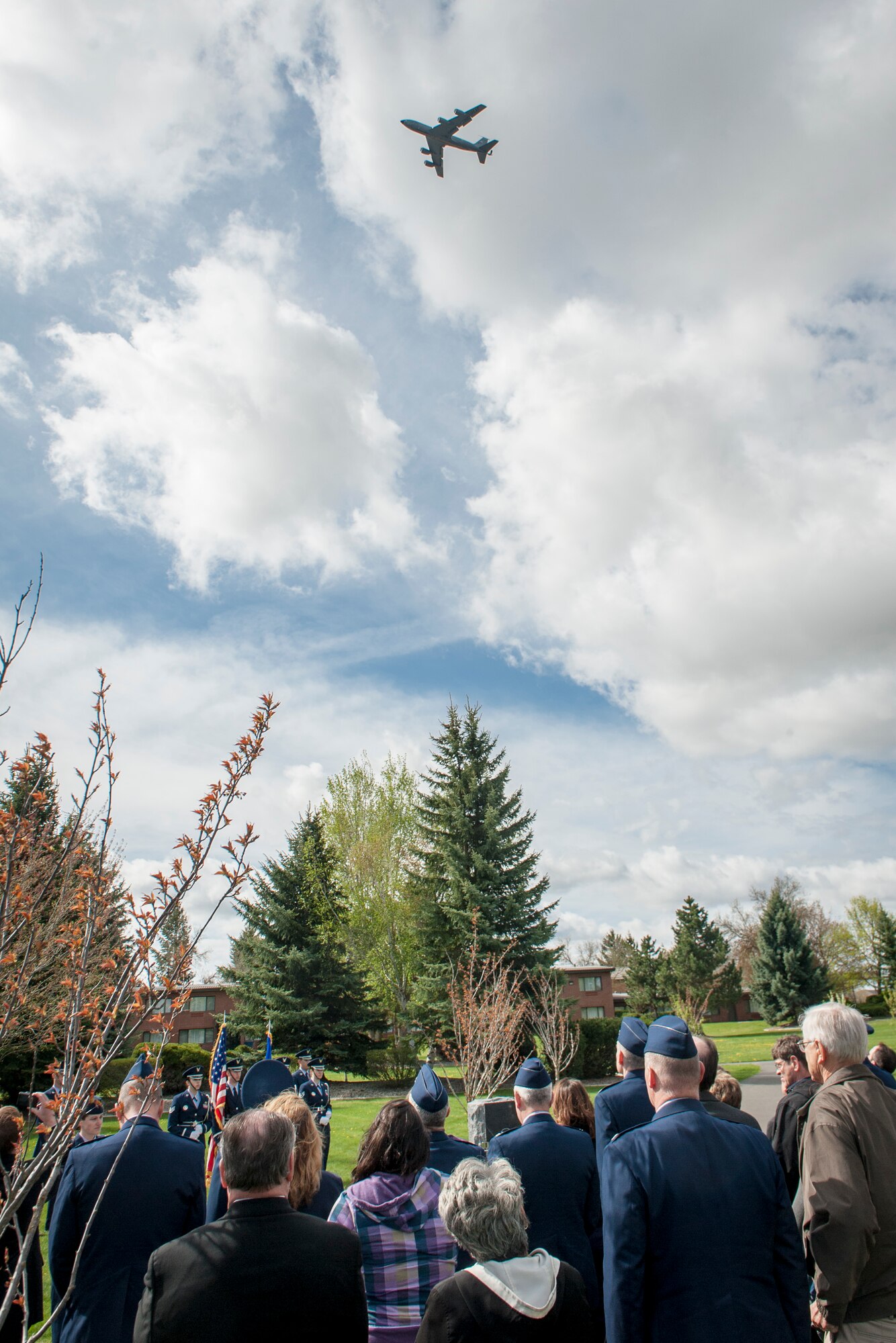 Family, friends, coworkers and neighbors of three fallen Fairchild Airmen who tragically perished one year ago in a KC-135 Stratotanker crash in northern Kyrgyzstan watch as a KC-135 flies overhead during a memorial dedication ceremony in the Fairchild Memorial Grove Park at Fairchild Air Force Base, Wash., May 3, 2014. "Shell 77" crewmembers honored were Capt. Mark T. "Tyler" Voss, Capt. Victoria A. "Tori" Pinckney and Tech. Sgt. Herman "Tre" Mackey III. During the ceremony, a granite memorial featuring a centerpiece and three benches were unveiled honoring these three Airmen keeping their memory alive at Fairchild. (U.S. Air Force photo by Staff Sgt. Benjamin W. Stratton/Released)