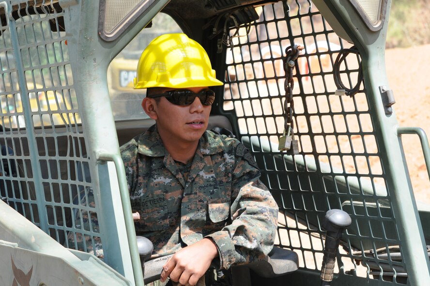 A Guatemalan engineer operates heavy equipment after training with 188th Civil Engineer Squadron Airmen at the new school worksite at El Roble during Beyond the Horizon 2014 on April 10. U.S. Army South is partnering with Guatemala to execute Beyond the Horizon, a focused humanitarian assistance operation conducting various engineering assistance, medical, dental and civic action programs. (U.S. Army National Guard photo by Lt. Col. Richard D. Garringer/released)