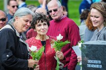 Family members of three fallen Fairchild Airmen who tragically perished one year ago in a KC-135 Stratotanker crash in northern Kyrgyzstan reflect during a memorial dedication ceremony in the Fairchild Memorial Grove Park at Fairchild Air Force Base, Wash., May 3, 2014. "Shell 77" crewmembers honored were Capt. Mark T. "Tyler" Voss, Capt. Victoria A. "Tori" Pinckney and Tech. Sgt. Herman "Tre" Mackey III. During the ceremony, a granite memorial featuring a centerpiece and three benches were unveiled honoring these three Airmen keeping their memory alive at Fairchild. Newberry is the 92nd Air Refueling Wing commander. (U.S. Air Force photo by Staff Sgt. Benjamin W. Stratton/Released)
