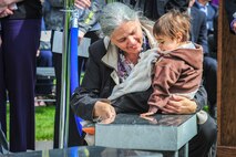 Family members of three fallen Fairchild Airmen who tragically perished one year ago in a KC-135 Stratotanker crash in northern Kyrgyzstan reflect during a memorial dedication ceremony in the Fairchild Memorial Grove Park at Fairchild Air Force Base, Wash., May 3, 2014. "Shell 77" crewmembers honored were Capt. Mark T. "Tyler" Voss, Capt. Victoria A. "Tori" Pinckney and Tech. Sgt. Herman "Tre" Mackey III. During the ceremony, a granite memorial featuring a centerpiece and three benches were unveiled honoring these three Airmen keeping their memory alive at Fairchild. (U.S. Air Force photo by Staff Sgt. Benjamin W. Stratton/Released)