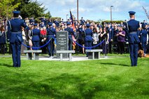Staff Sgt. Abigail Foster sings the National Anthem as family, friends, coworkers and neighbors of three fallen Fairchild Airmen who tragically perished one year ago in a KC-135 Stratotanker crash in northern Kyrgyzstan reflect during a memorial dedication ceremony in the Fairchild Memorial Grove Park at Fairchild Air Force Base, Wash., May 3, 2014. "Shell 77" crewmembers honored were Capt. Mark T. "Tyler" Voss, Capt. Victoria A. "Tori" Pinckney and Tech. Sgt. Herman "Tre" Mackey III. During the ceremony, a granite memorial featuring a centerpiece and three benches were unveiled honoring these three Airmen keeping their memory alive at Fairchild. Foster is a member of the 92nd Maintenance Squadron. (U.S. Air Force photo by Staff Sgt. Benjamin W. Stratton/Released)