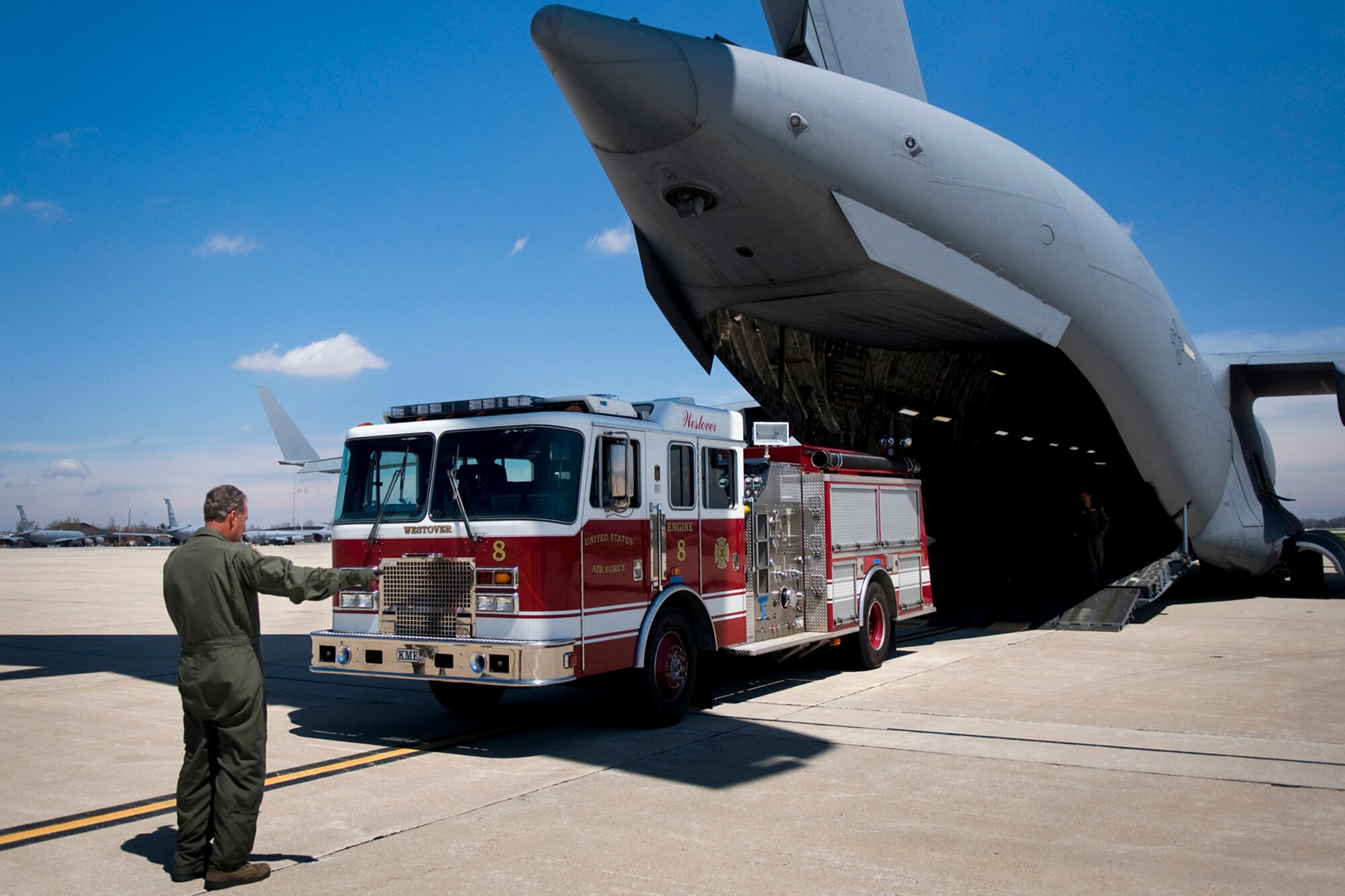 Senior Master Sgt. Bill Lamela, 729th Airlift Squadron loadmaster from March Air Reserve Base, Calif., guides a fire truck into a C-17 Globemaster III aircraft at Grissom Air Reserve Base, Ind., April 25, 2014, during a Patriot Warrior exercise. Patriot Warrior is a joint, field-training exercise for theater aeromedical evacuation systems and ground medical components designed to replicate all aspects of combat medical service support. (U.S. Air Force photo/Tech. Sgt. Mark R. W. Orders-Woempner)
