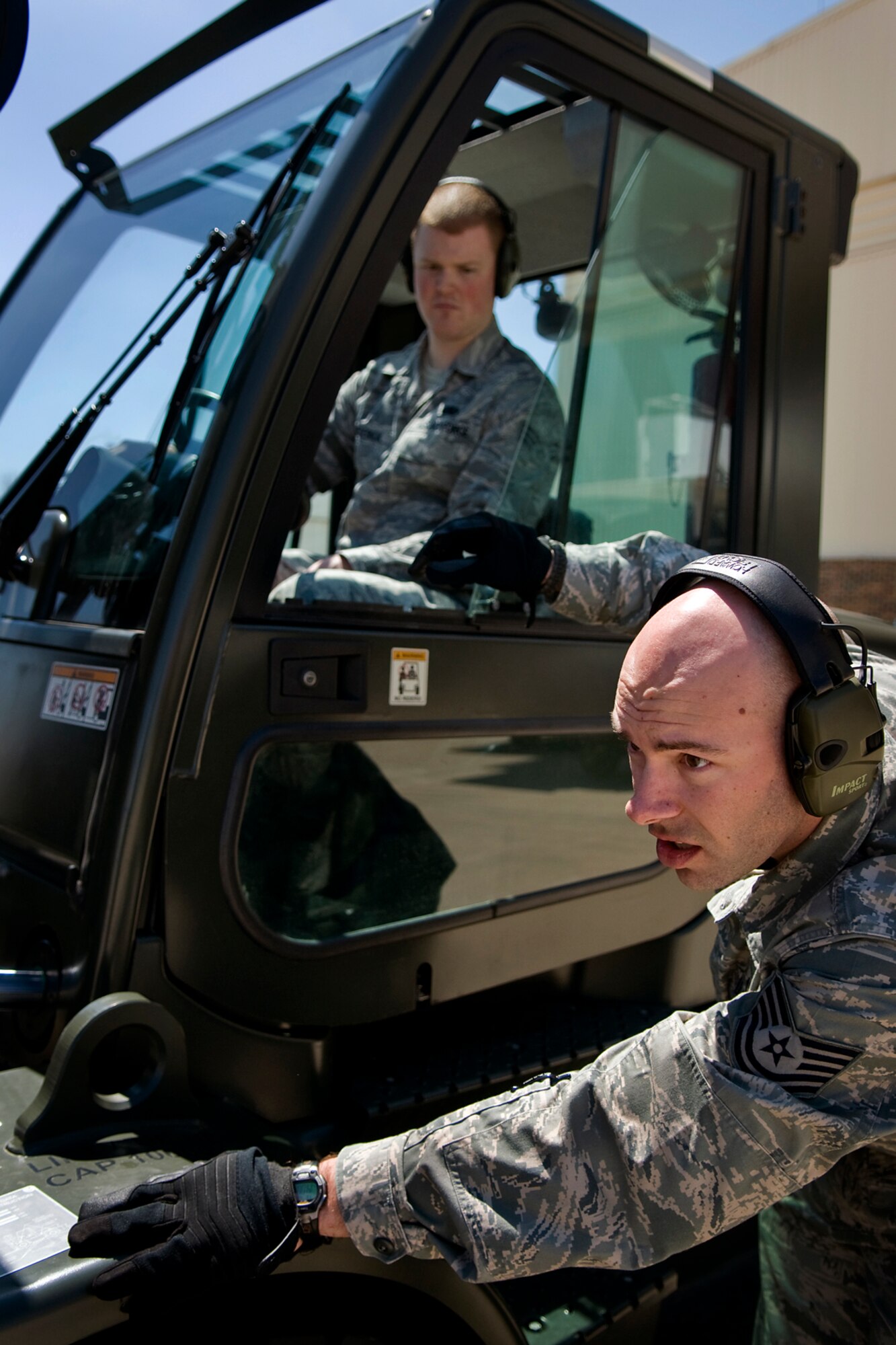 Tech. Sgt. Timothy Lyvers, right, 49th Aerial Port Squadron aerial port specialist from Grissom Air Reserve Base, Ind., checks clearance of a cargo pallet being loaded onto a Halvorsen loader as Senior Airman Zachery Frederick, 67th Aerial Port Squadron aerial port specialist from Hill Air Force Base, Utah, watches Lyvers' directions as Frederick controls a 10K standard forklift being used to load the cargo at Grissom April 25, 2014, during a Patriot Warrior exercise. Patriot Warrior is a joint, field-training exercise for theater aeromedical evacuation systems and ground medical components designed to replicate all aspects of combat medical service support. (U.S. Air Force photo/Tech. Sgt. Mark R. W. Orders-Woempner)
