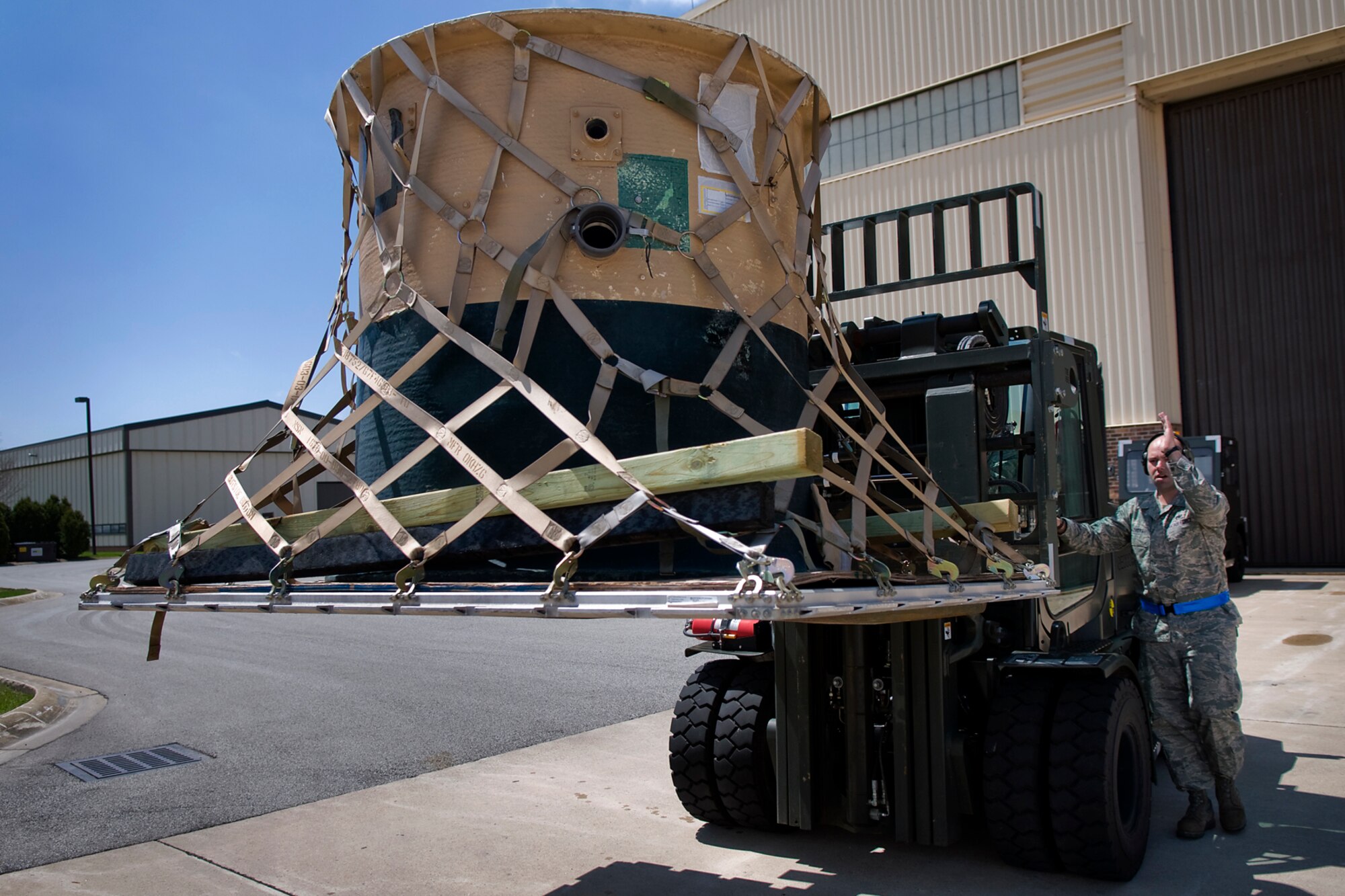 Tech. Sgt. Timothy Lyvers, right, 49th Aerial Port Squadron aerial port specialist from Grissom Air Reserve Base, Ind., directs Senior Airman Zachery Frederick, 67th Aerial Port Squadron aerial port specialist from Hill Air Force Base, Utah, as Frederick uses a 10K standard forklift to load a cargo pallet onto a Halvorsen loader at Grissom April 25, 2014, during a Patriot Warrior exercise. Patriot Warrior is a joint, field-training exercise for theater aeromedical evacuation systems and ground medical components designed to replicate all aspects of combat medical service support. (U.S. Air Force photo/Tech. Sgt. Mark R. W. Orders-Woempner)