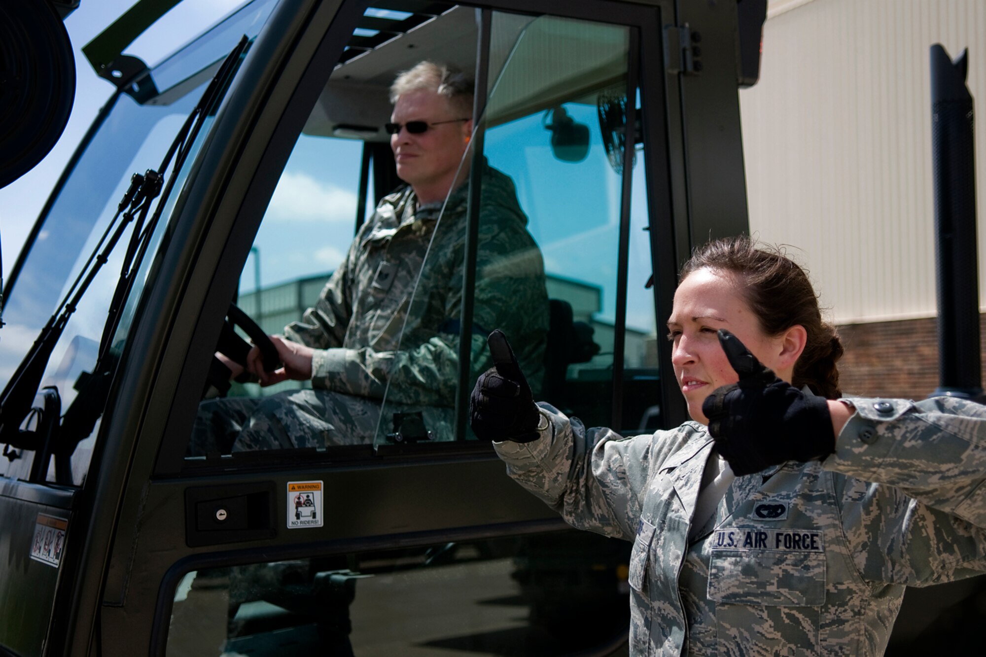 Senior Airman Mallory Cole, right, 81st Aerial Port Squadron aerial port specialist from Charleston Air Force Base, S.C., directs Staff Sgt. Steven Bourff, 49th Aerial Port Squadron aerial port specialist from Grissom Air Reserve Base, Ind., as Bourff controls a 10K standard forklift being used to load the cargo at Grissom April 25, 2014, during a Patriot Warrior exercise. Patriot Warrior is a joint, field-training exercise for theater aeromedical evacuation systems and ground medical components designed to replicate all aspects of combat medical service support. (U.S. Air Force photo/Tech. Sgt. Mark R. W. Orders-Woempner)
