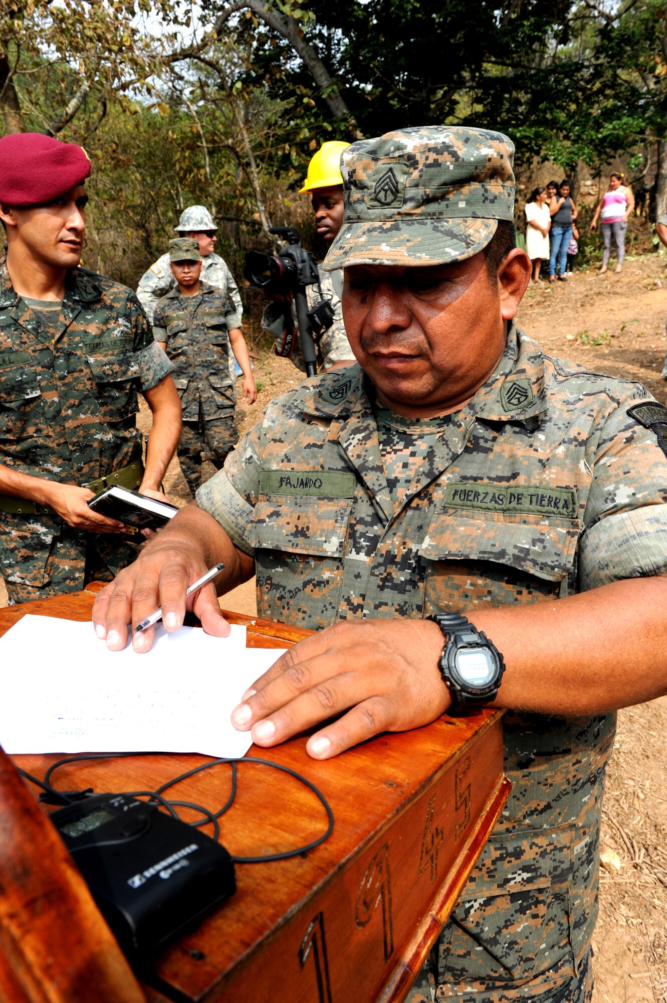 A Guatemalan Soldier of 2nd Infantry Brigade prepares the podium for the start of the groundbreaking ceremony for a school construction project being built by the 188th Civil Engineer Squadron, Arkansas Air National Guard, assigned to Task Force Oso for Exercise Beyond the Horizons near El Robles, Guatemala, April 8th, 2014.  Beyond the Horizons is a humanitarian and civic assistance mission deploying U.S. military engineers and medical professionals to Guatemala for training and to provide humanitarian services. (U.S. Army photo by Staff Sgt. Michael L. Casteel)