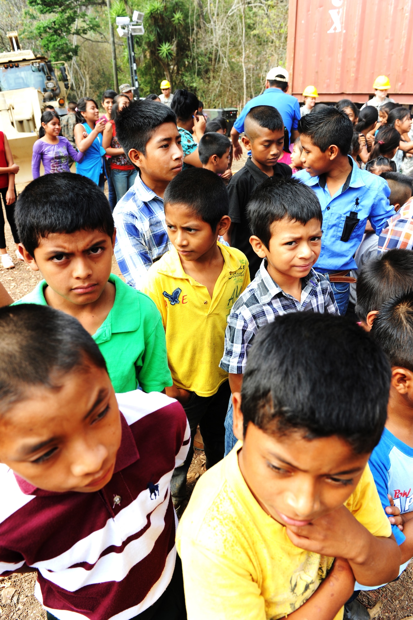 Guatemalan children await the start of the ground breaking ceremony for a school construction project being built by 188th Civil Engineer Squadron assigned to Task Force Oso for Exercise Beyond the Horizon near El Robles, Guatemala, April 8, 2014.  Beyond the Horizon is a humanitarian and civic assistance mission deploying U.S. military engineers and medical professionals to Guatemala for training and to provide humanitarian services. (U.S. Army Photo by Staff Sgt. Michael L. Casteel) 